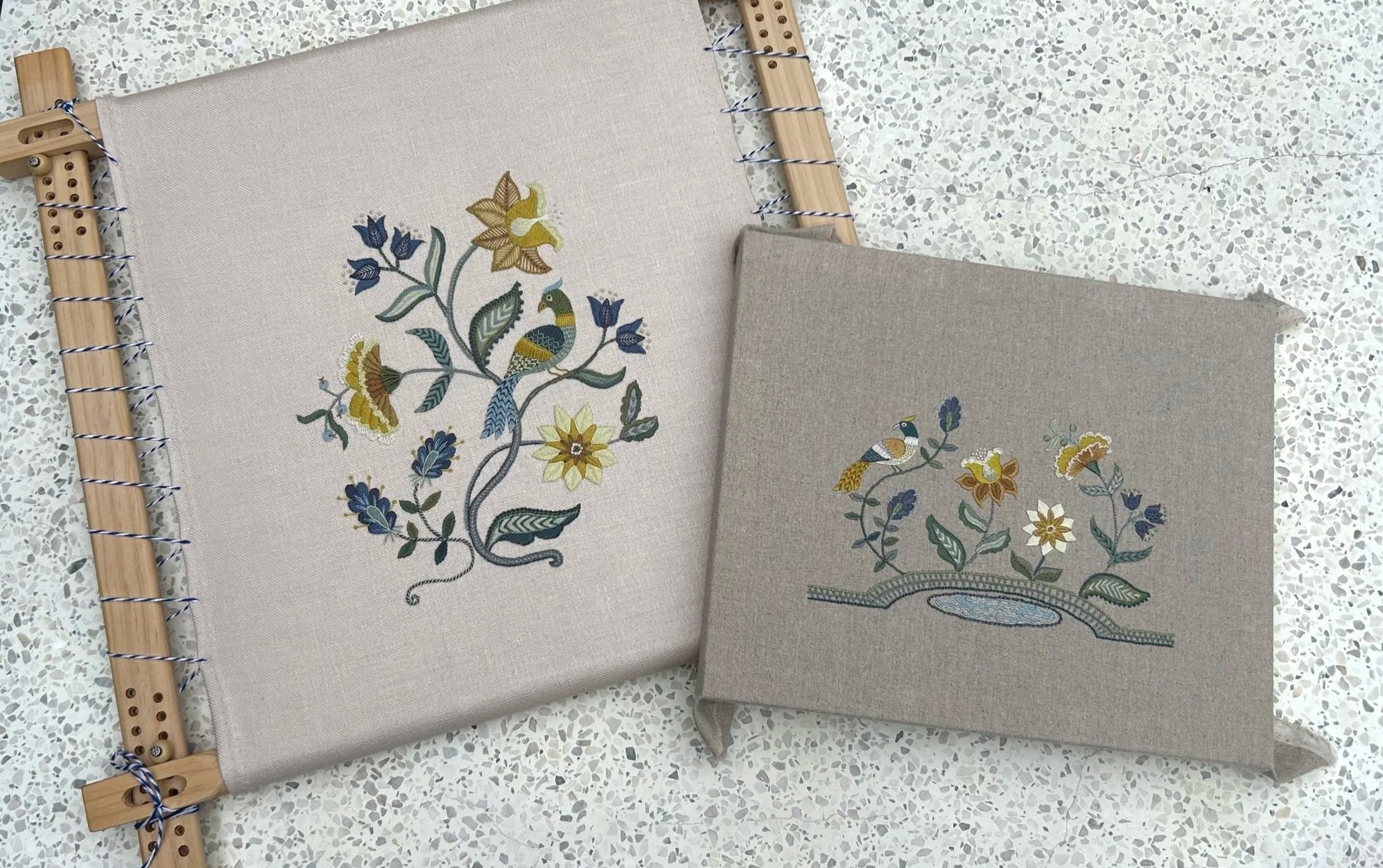 Same design repeated. Crewel work and silk embroidery. Exotic flowers and a bird stitches in shades of golden yellow, soft blue-green and deep blue.