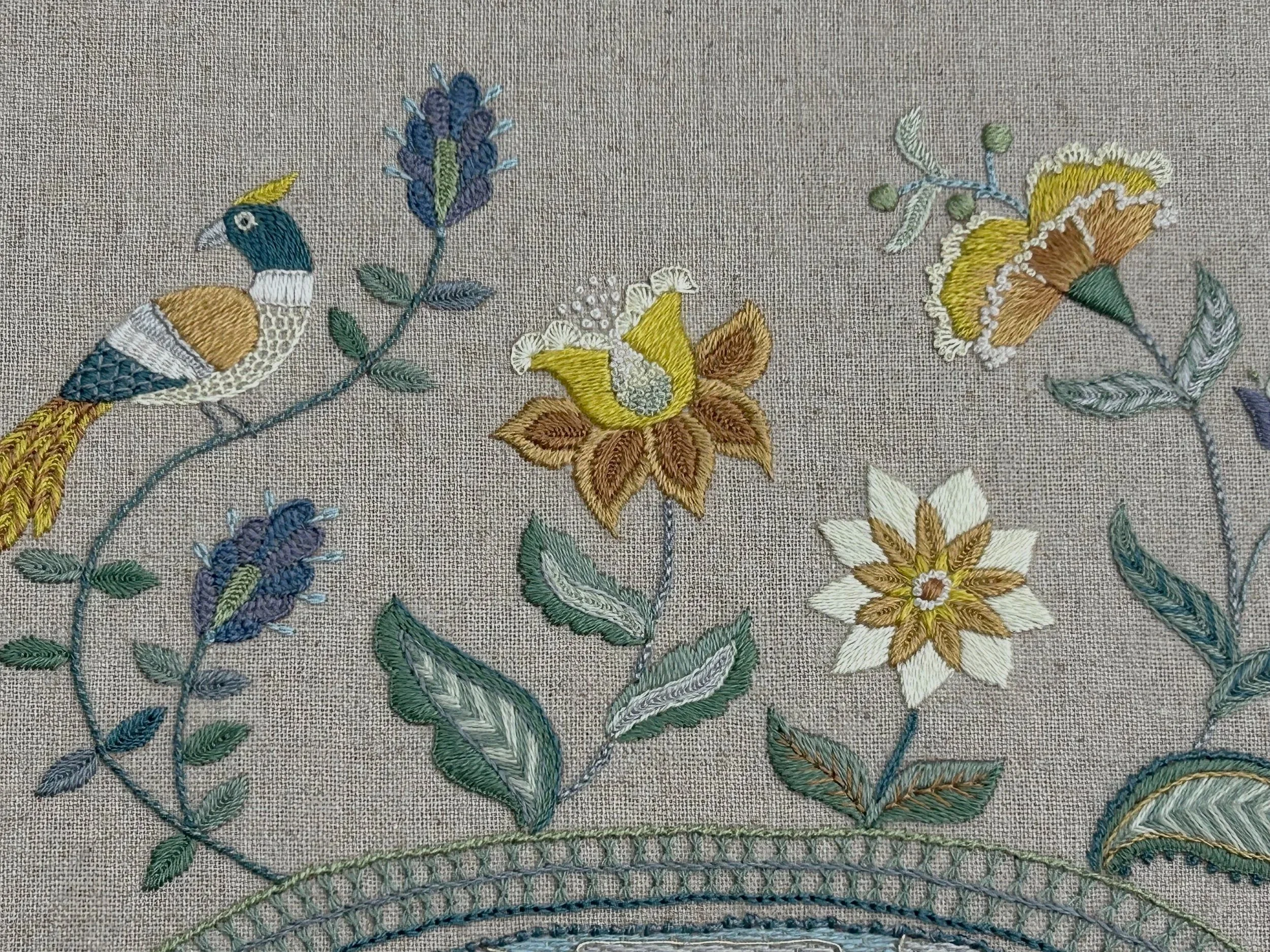 Silk embroidery. Border of exotic flowers and a bird embroidered in shades of golden yellow, soft greens and deep blue.