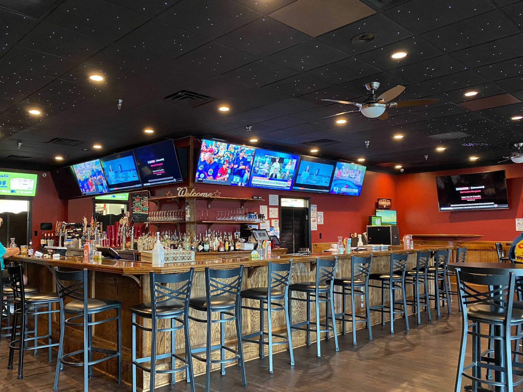 The Parkway Tavern bar with TVs, LED lights as stars in the ceiling, and available alcohol.