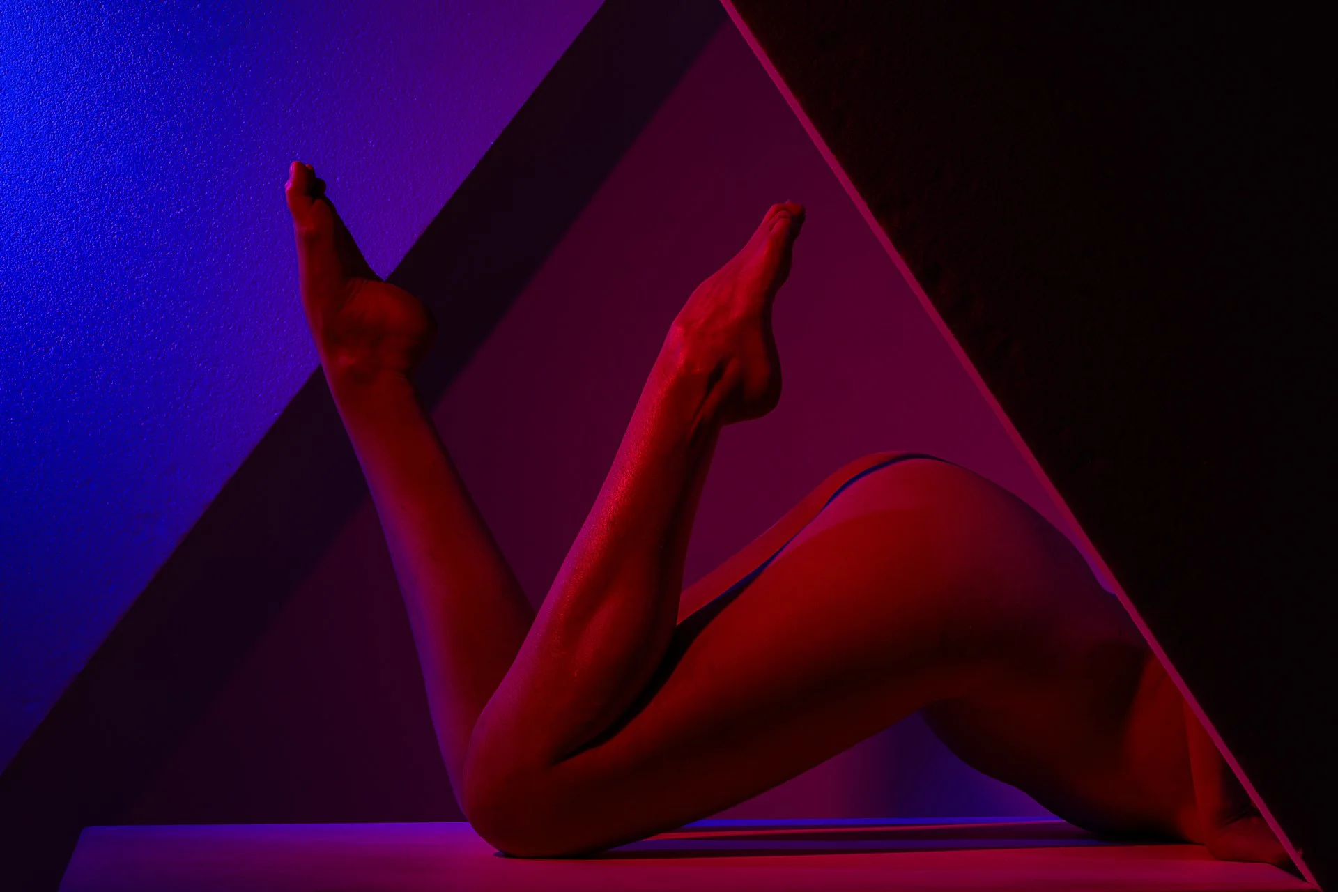 Triangle; nude female legs and bottom in a triangle.
