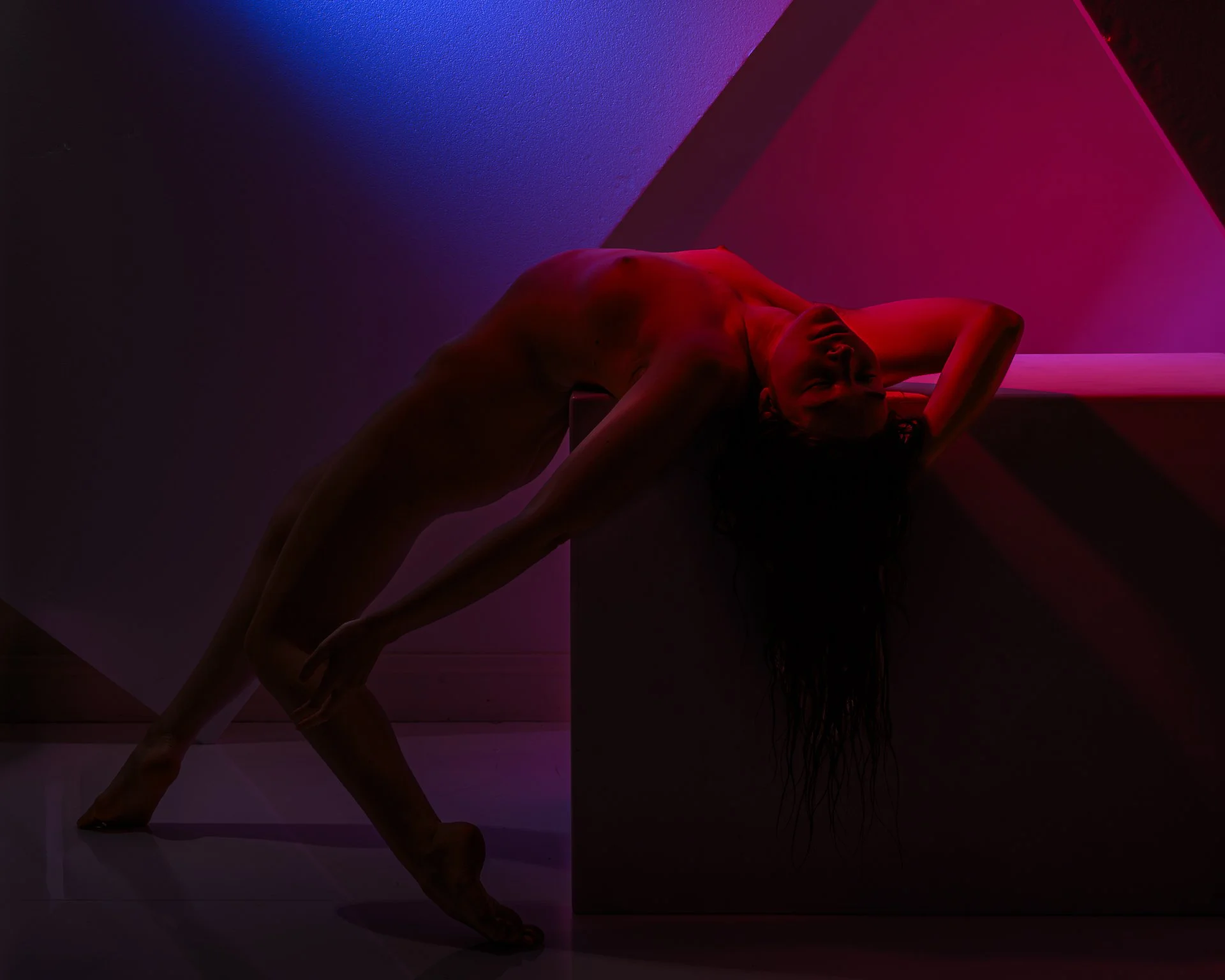 nude female on her back on a block