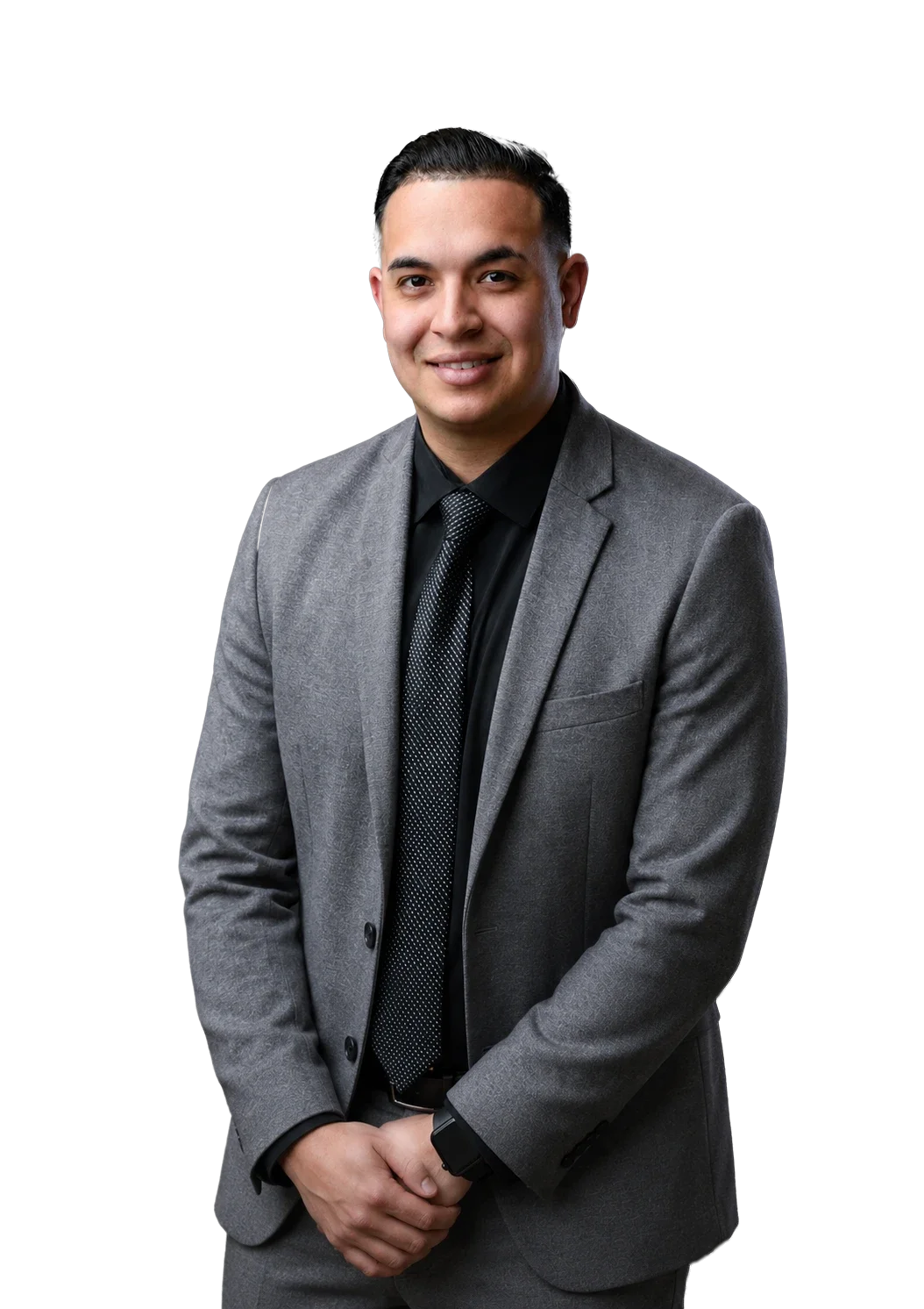 A young man in a gray suit with a black shirt and tie, smiling, posing against a plain background.
