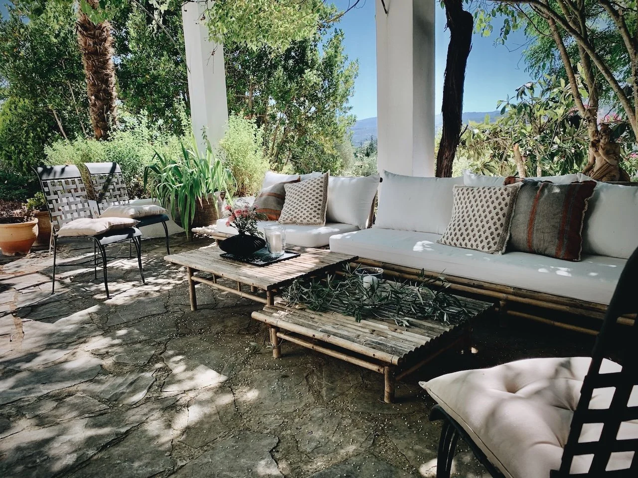 Sofa lounge area under wisteria at Finca La Marquesa, a peaceful holiday home near Ronda in Andalusia