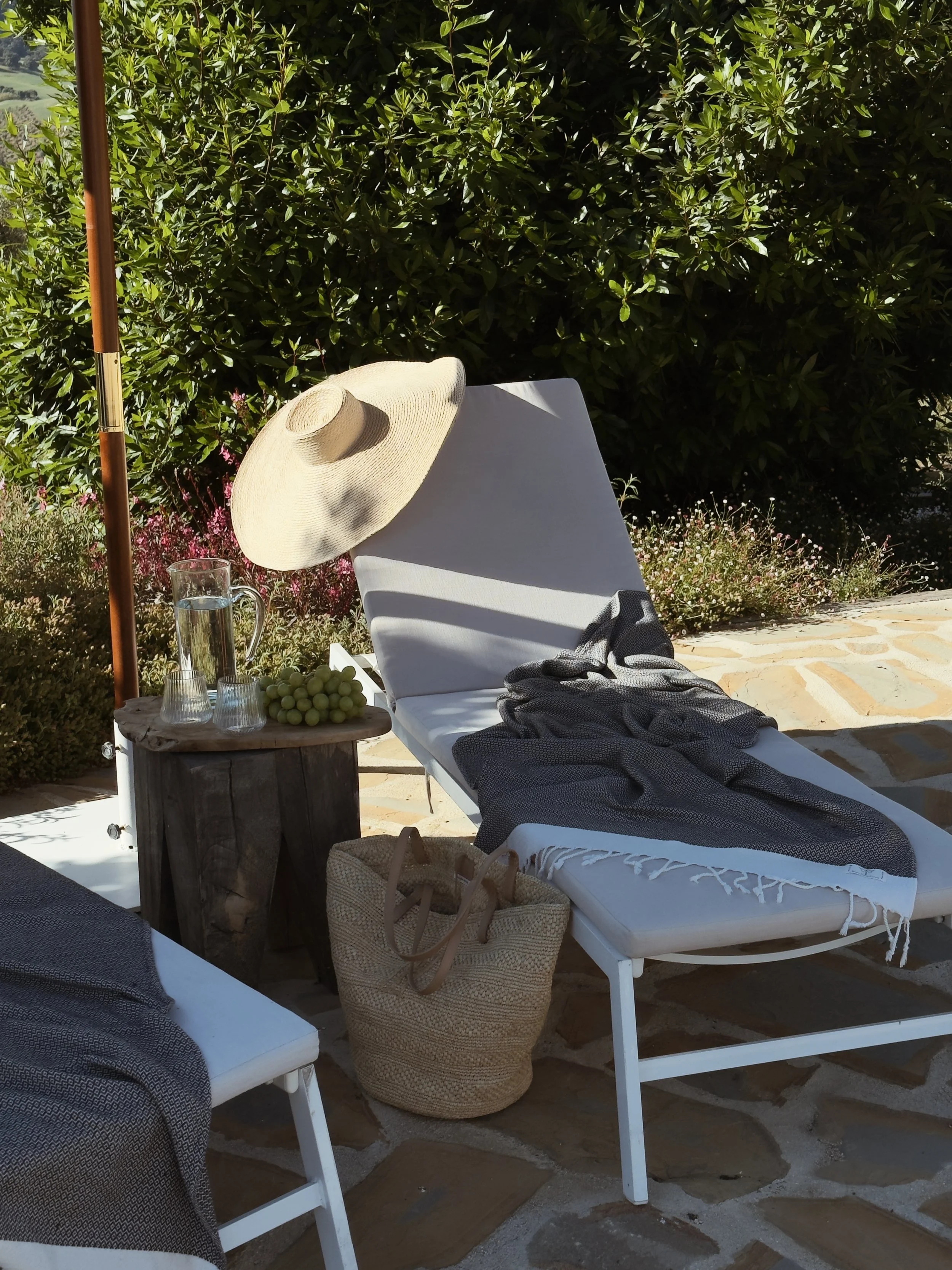 Luxury poolside relaxation at Finca La Marquesa, with sun loungers, Mediterranean gardens and peaceful surroundings near Ronda, Andalusia, Spain.