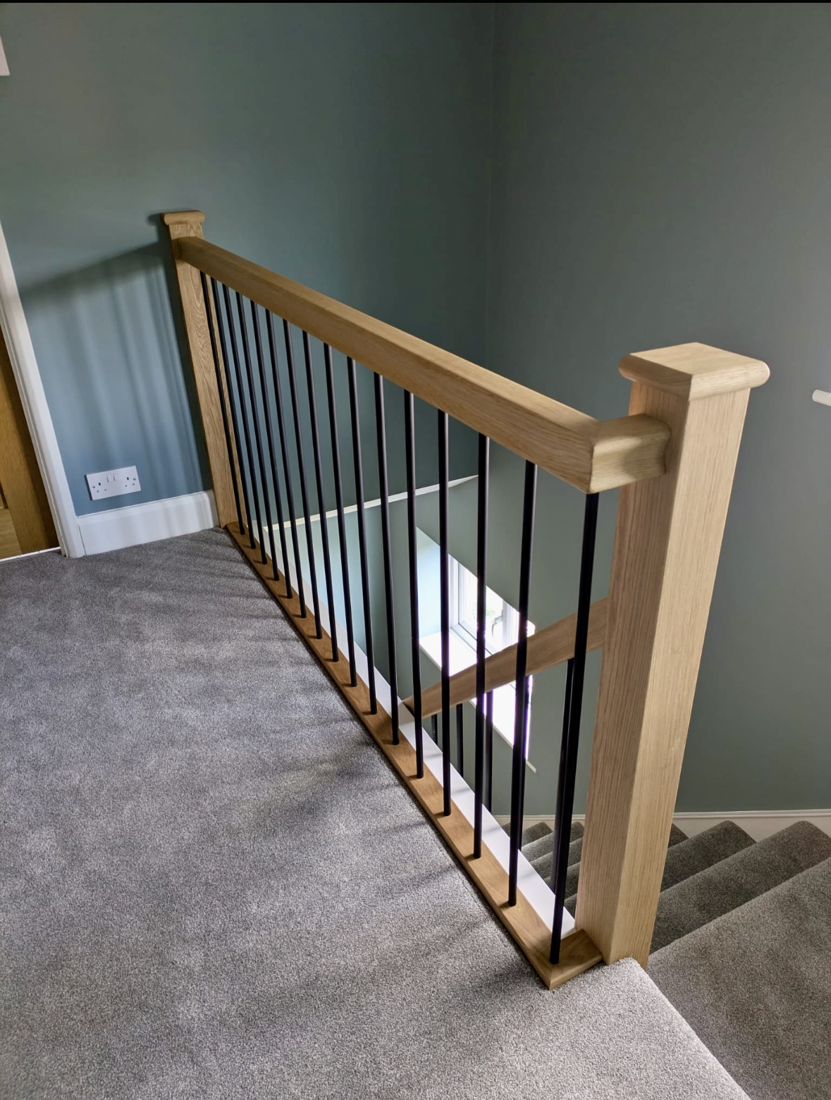 black metal spindles with oak handrail and newel post 