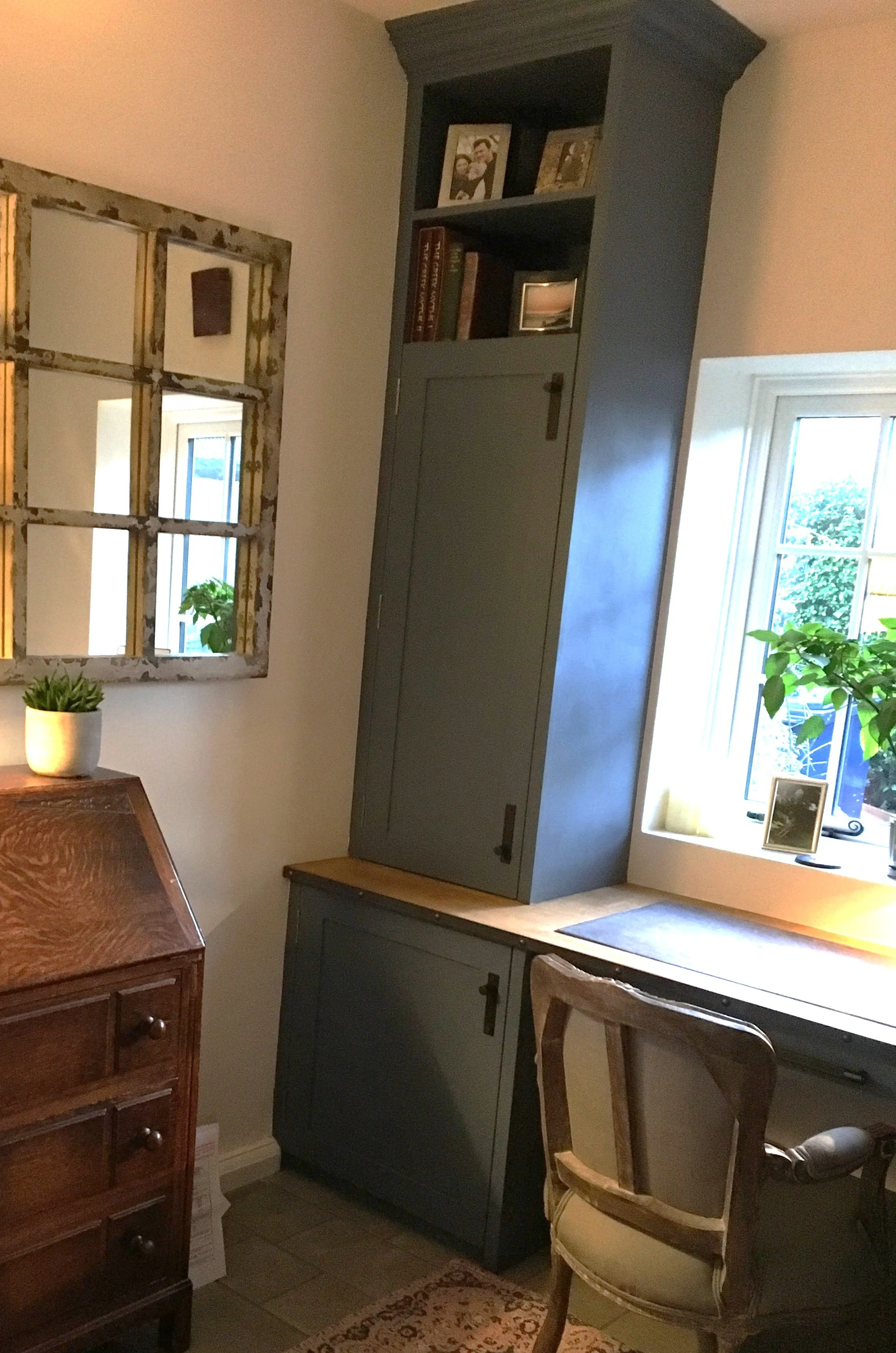 dark green custom-made tall cupboard and shelving in shaker style study
