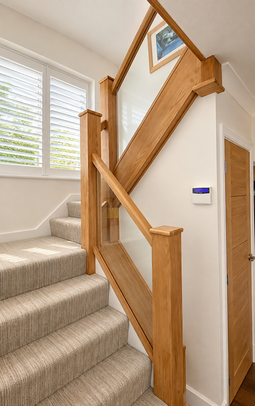 Modern Oak stair way landing with glass balustrade