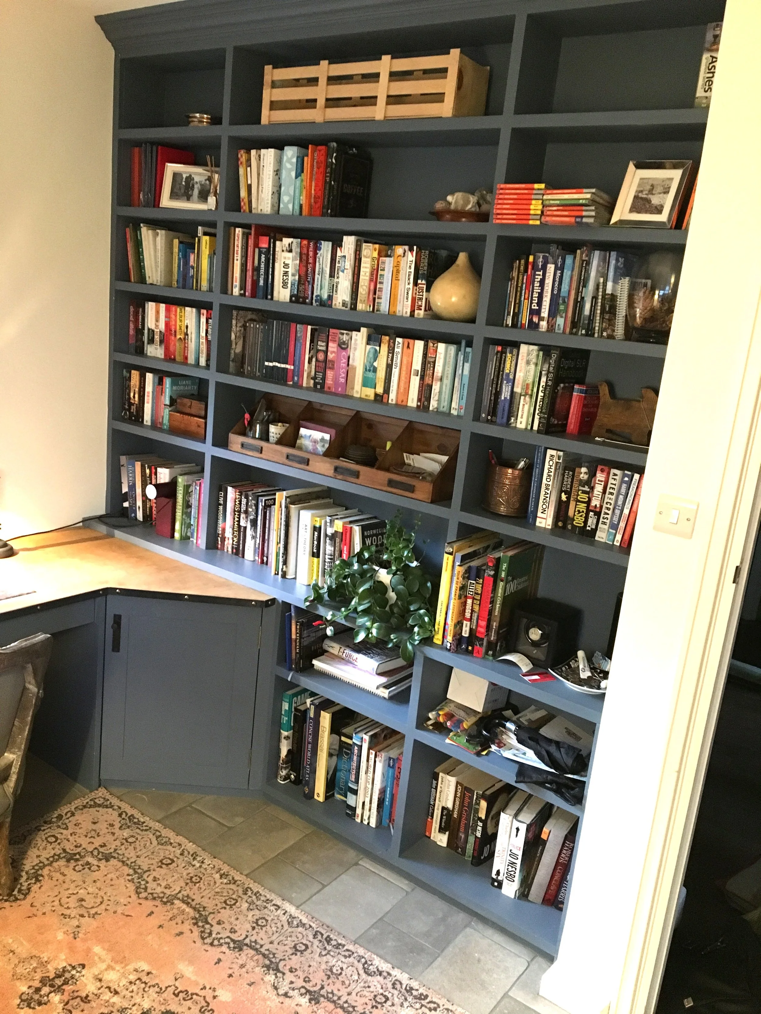 full wall shelving unit in home office dark green