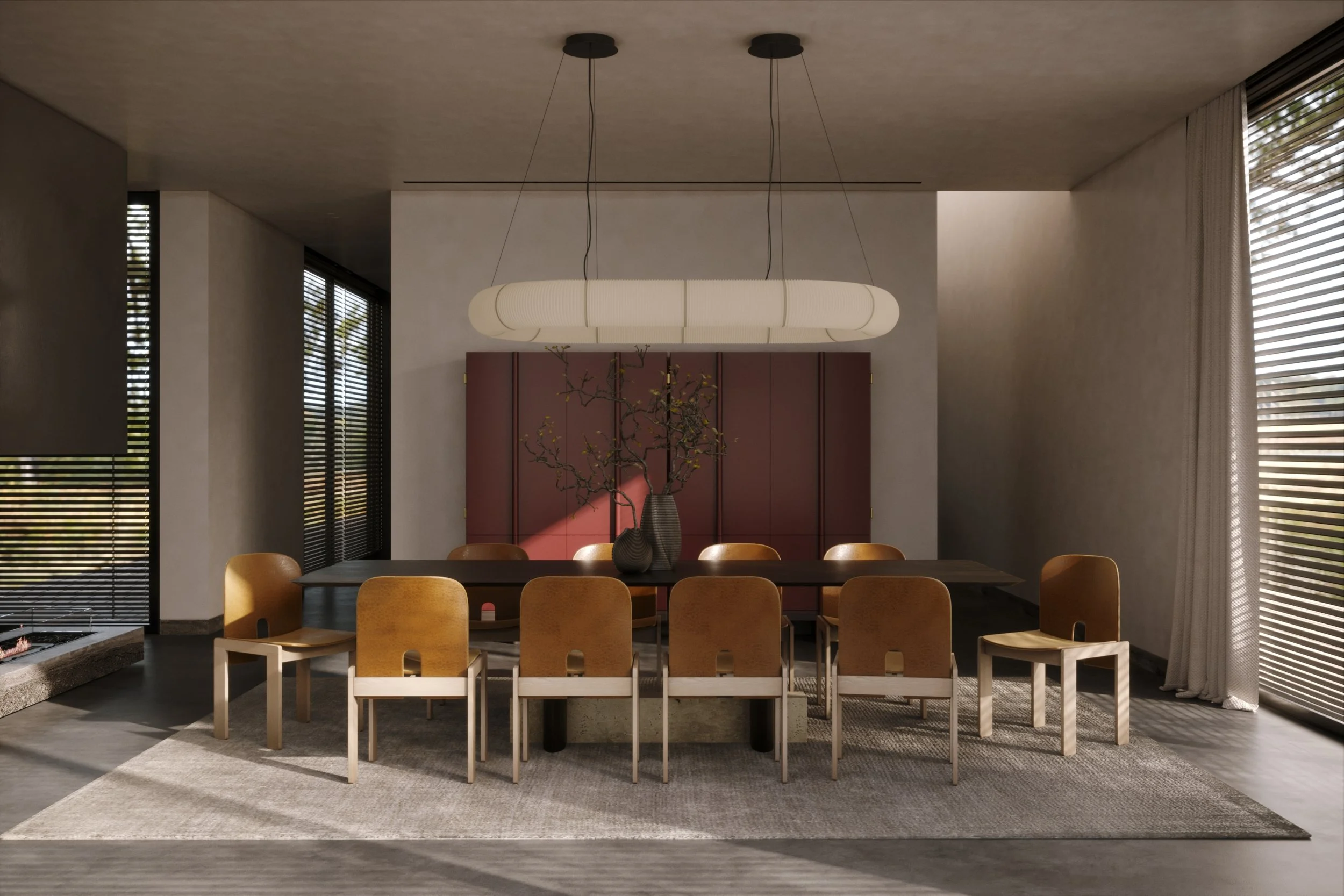 Modern dining room with a dark wooden table, nine mustard-colored chairs, a central vase with bare branches, a hanging white light fixture, large windows with blinds, and a neutral color palette.
