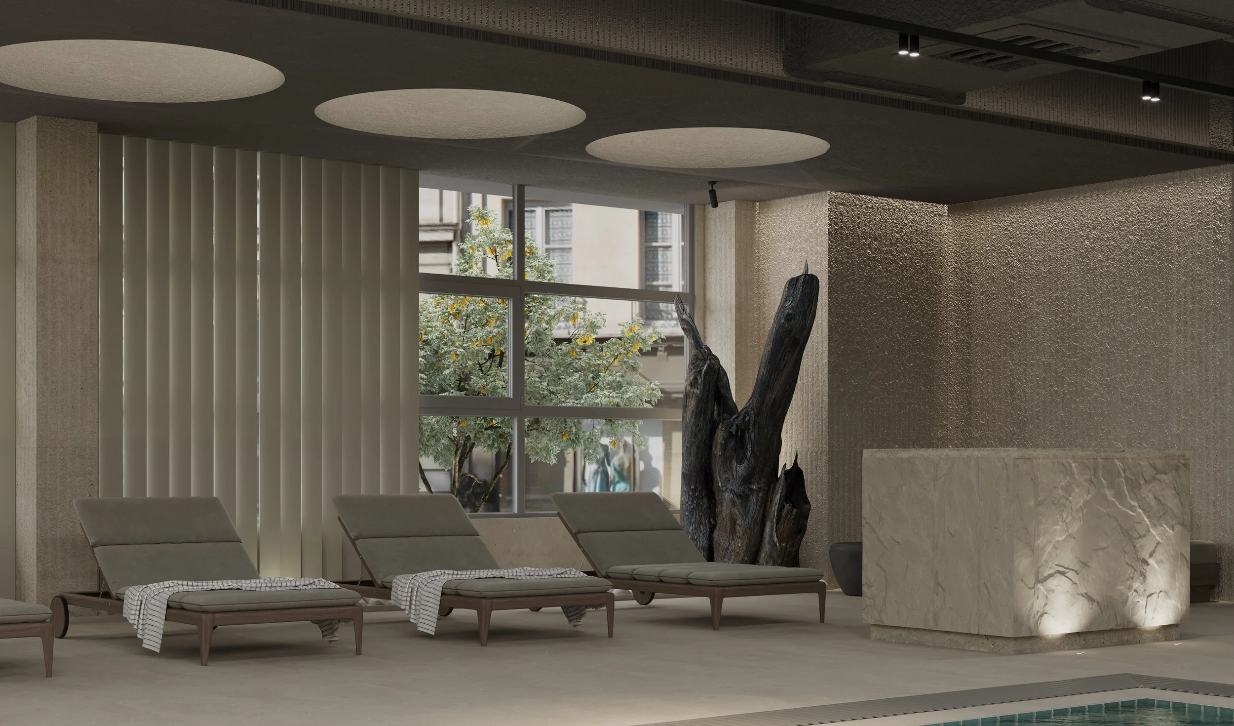 Indoor space with lounge chairs, large window with blinds, a tree outside, decorative wood in the center, and textured walls.