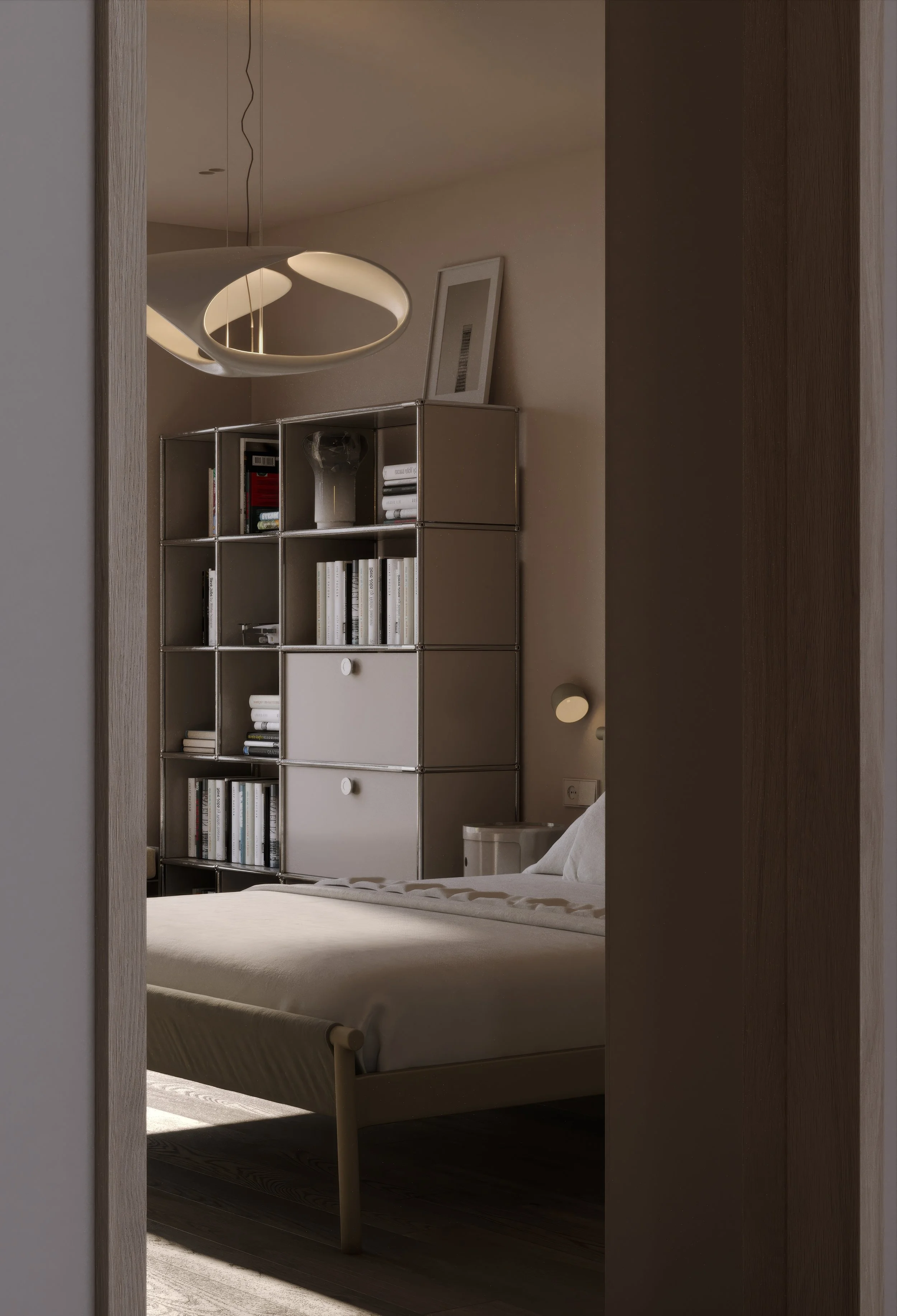 A bedroom with a bed, a modern bookshelf, and a light fixture, viewed through a doorway.