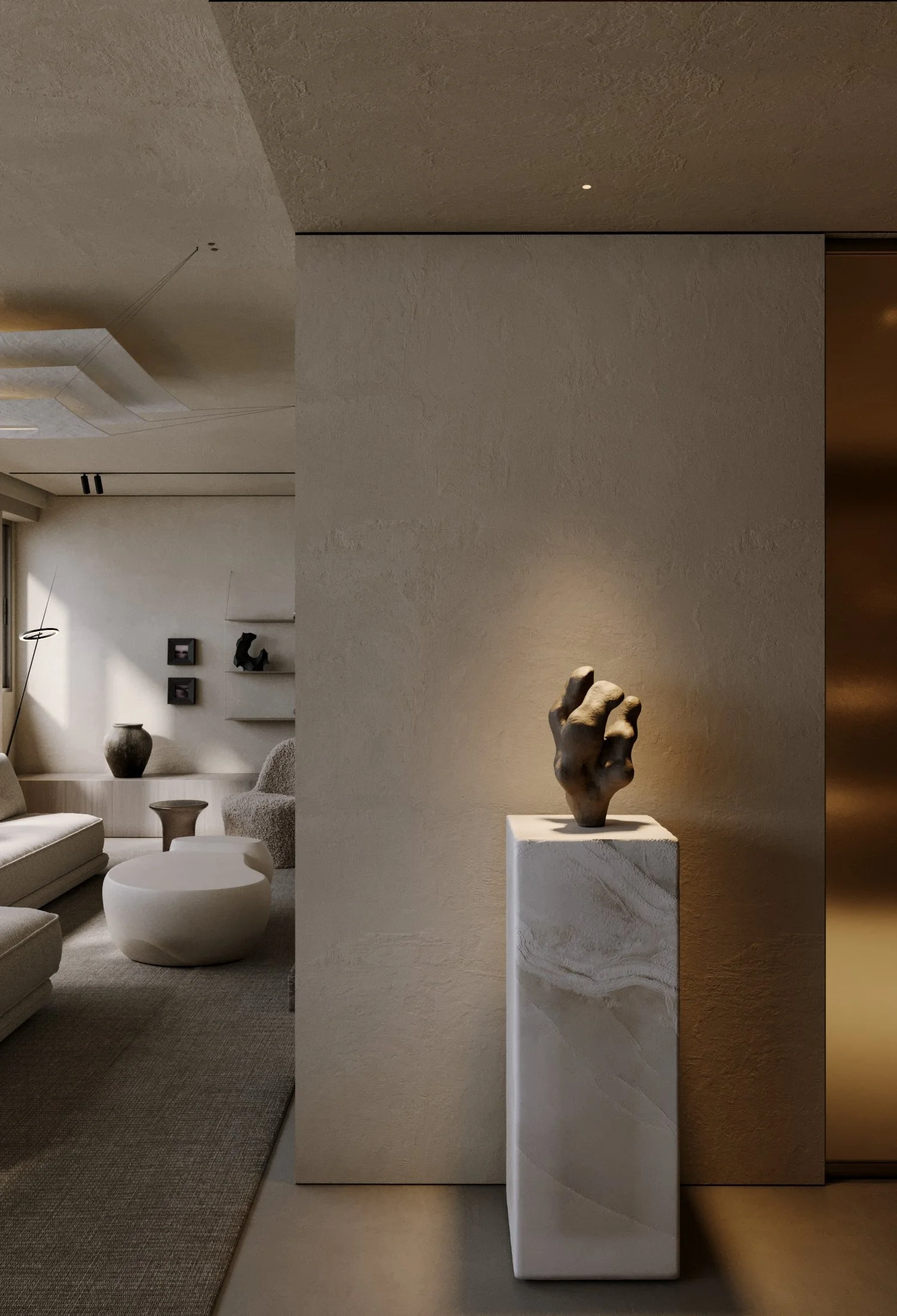Minimalist living room with beige furniture, a round ottoman, vases, and abstract decor on white and beige walls, with a sculpture on a pedestal in the foreground.
