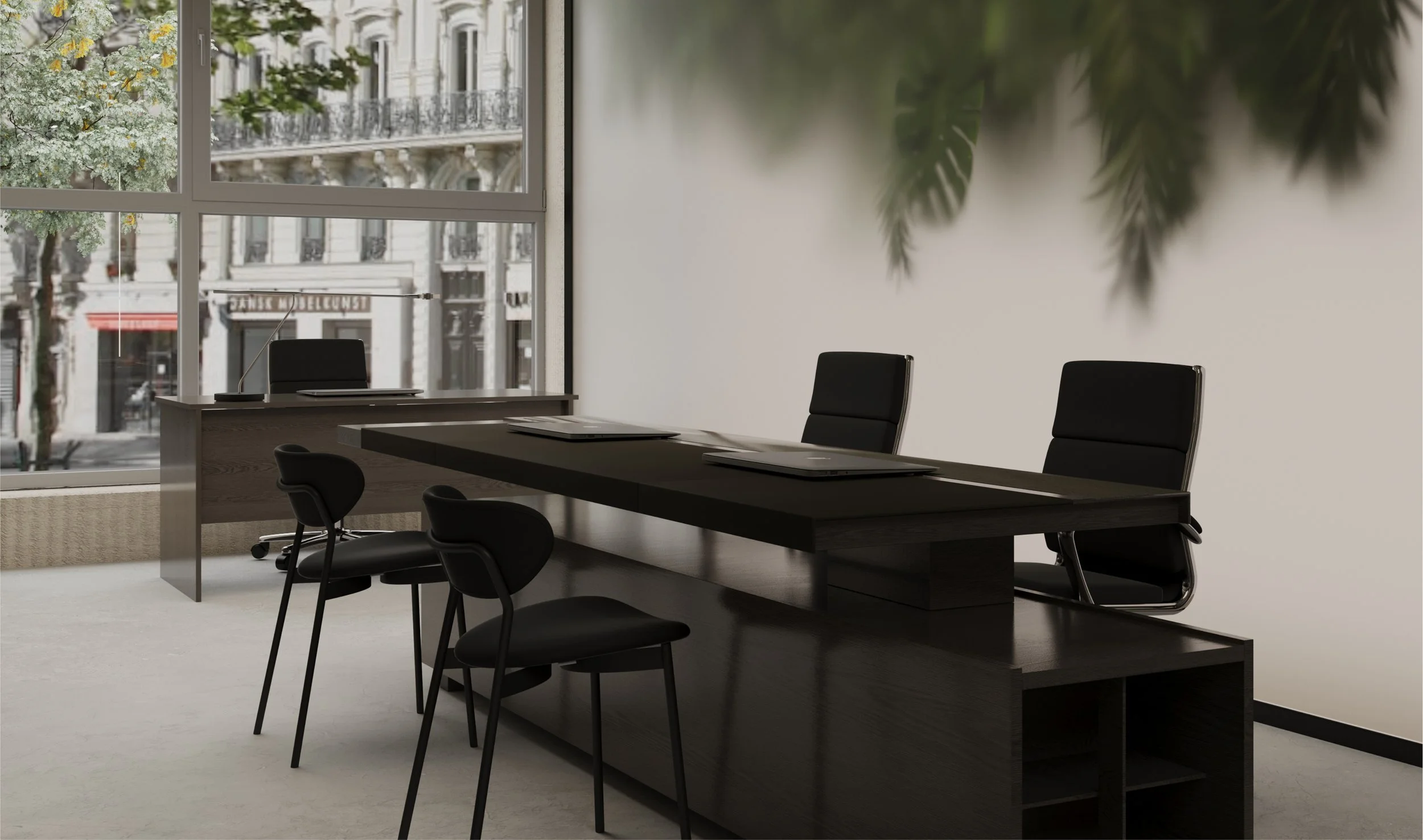Modern office conference room with a large dark wooden table, black chairs, and a desk near a large window showing city buildings and trees.