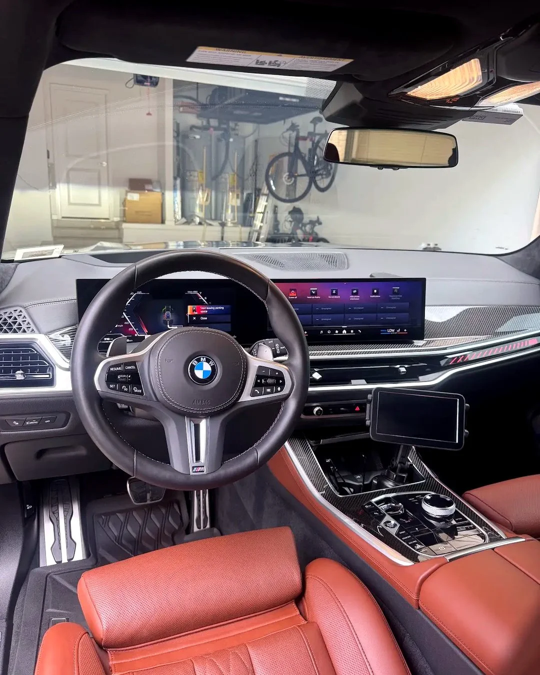 Clean driver area of a black BMW X5 after mobile detailing in Sandy Springs