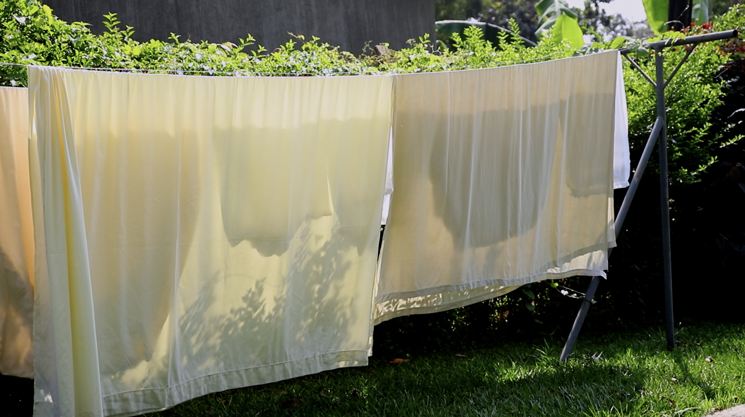 Cherish Uganda, End of Year 2026, Sheets on a line (still).png