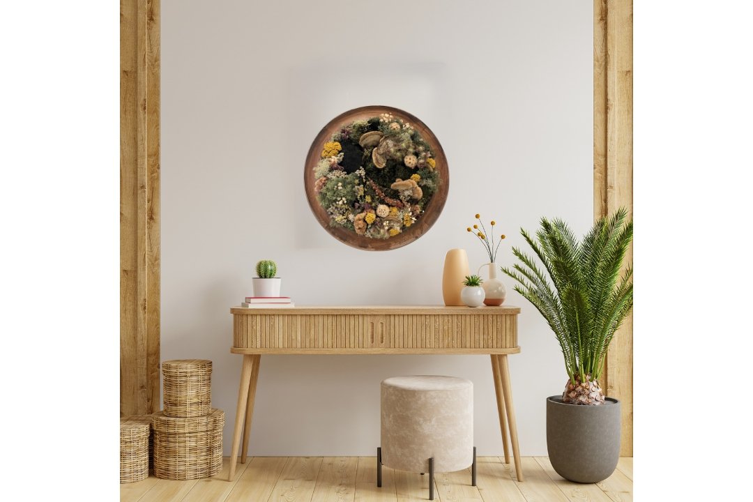 moss art in round oak frame, mosses, lichens and bright flowers on wall above stand