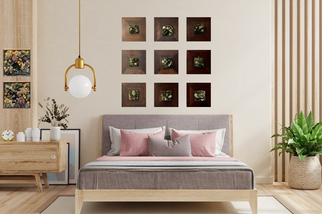 nine piece moss art installation gallery wall in wood frames on wall above bed