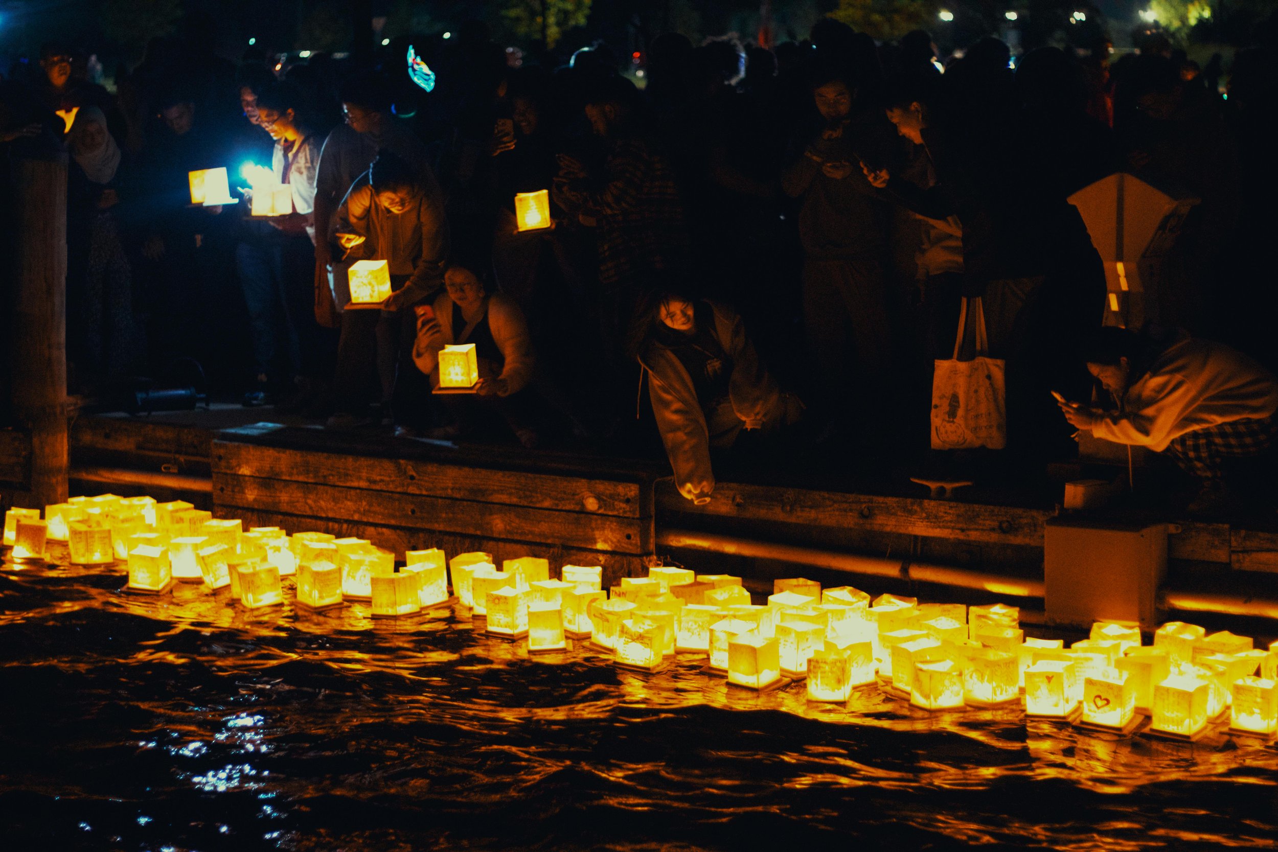 A serene night scene of floating lanterns during a festival
