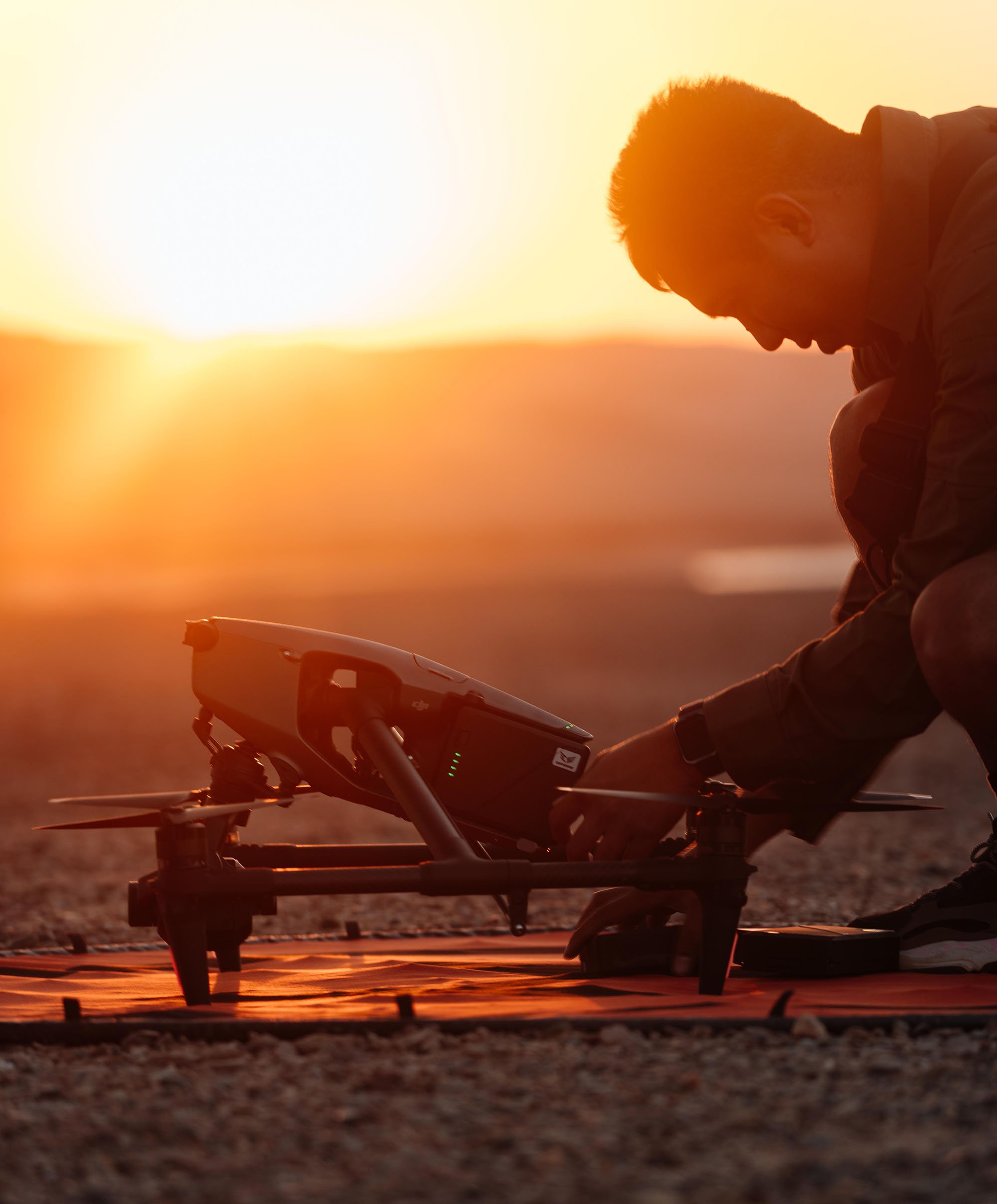 Drone operator with DJI Inspire 3 at sunset. Inspire 3, known for its stunning aerial imagery up to 8k resolution, is favored by filmmakers worldwide for its quick setup and exceptional performance.