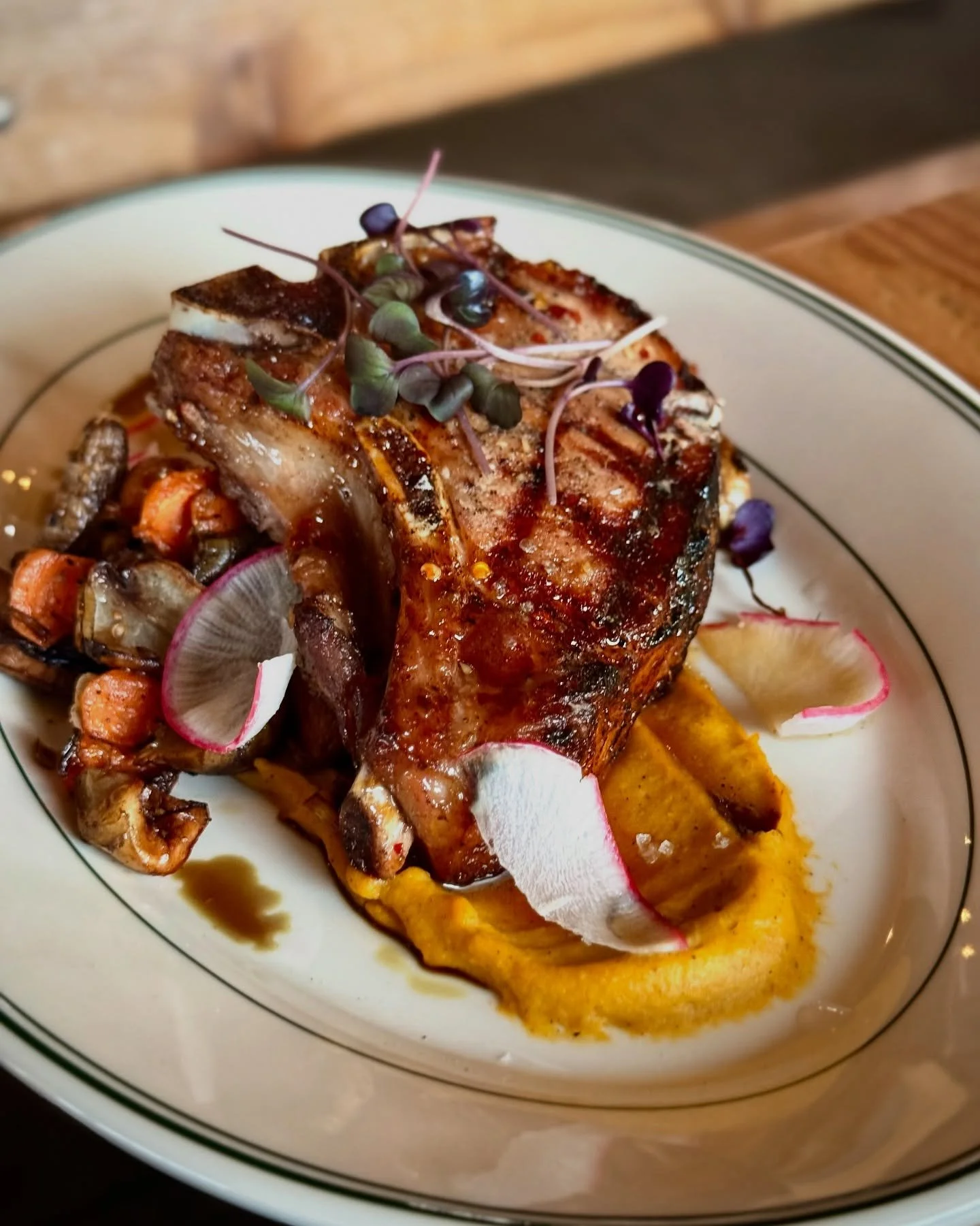 Maple-glazed pork chop

This new seasonal special is hitting the grill tonight. @olympiaprovisions 16oz pasture-raised bone-in loin chop. Roasted local sunchokes, leeks, and carrots. Roasted squash pur&eacute;e. Finished with pumpkin oil and microgre