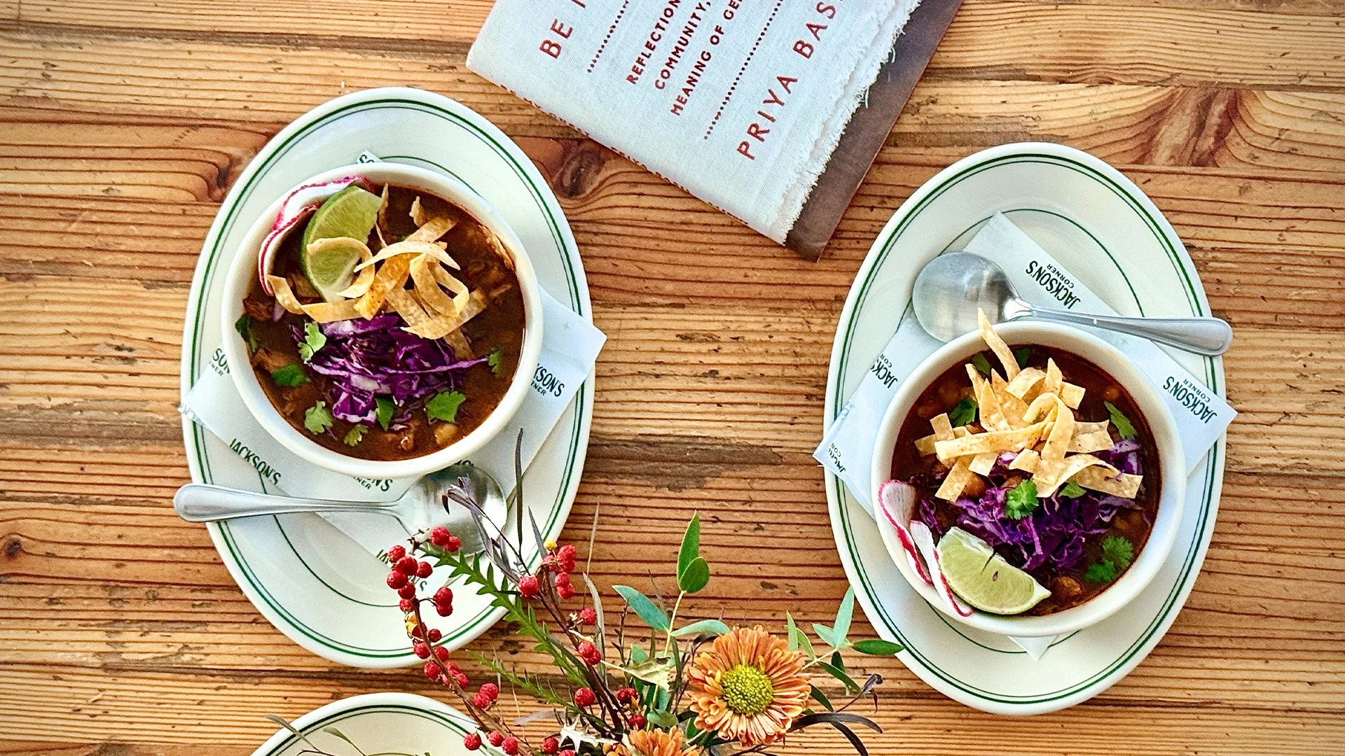 Two bowls of Chicken Pozole and flower arrangement from Jackson's Corner