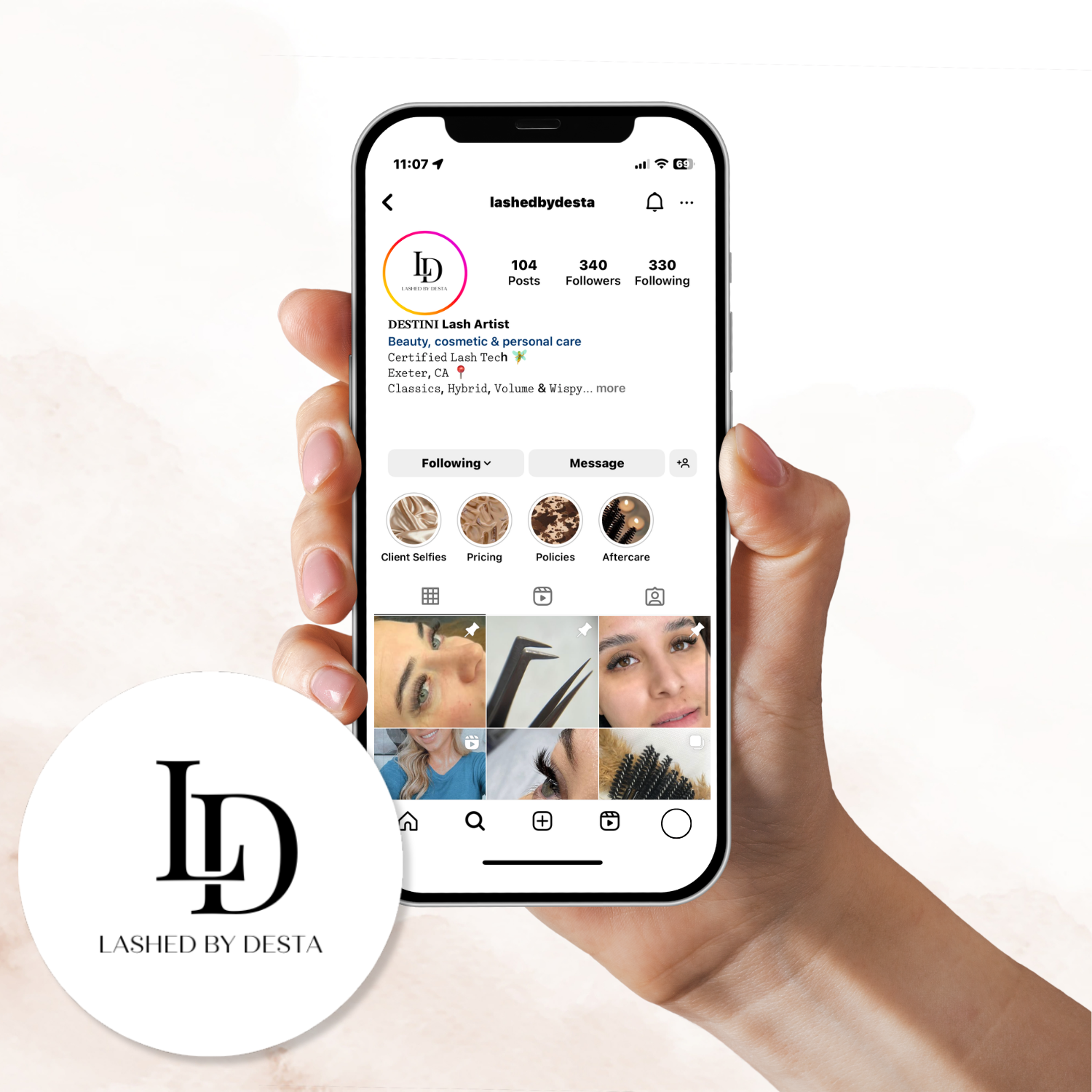 Hand holding a smartphone displaying an Instagram profile for "lashedbydesta", a lash artist, showing posts and follower information, with a logo for "Lashed by Desta" at the bottom left corner.