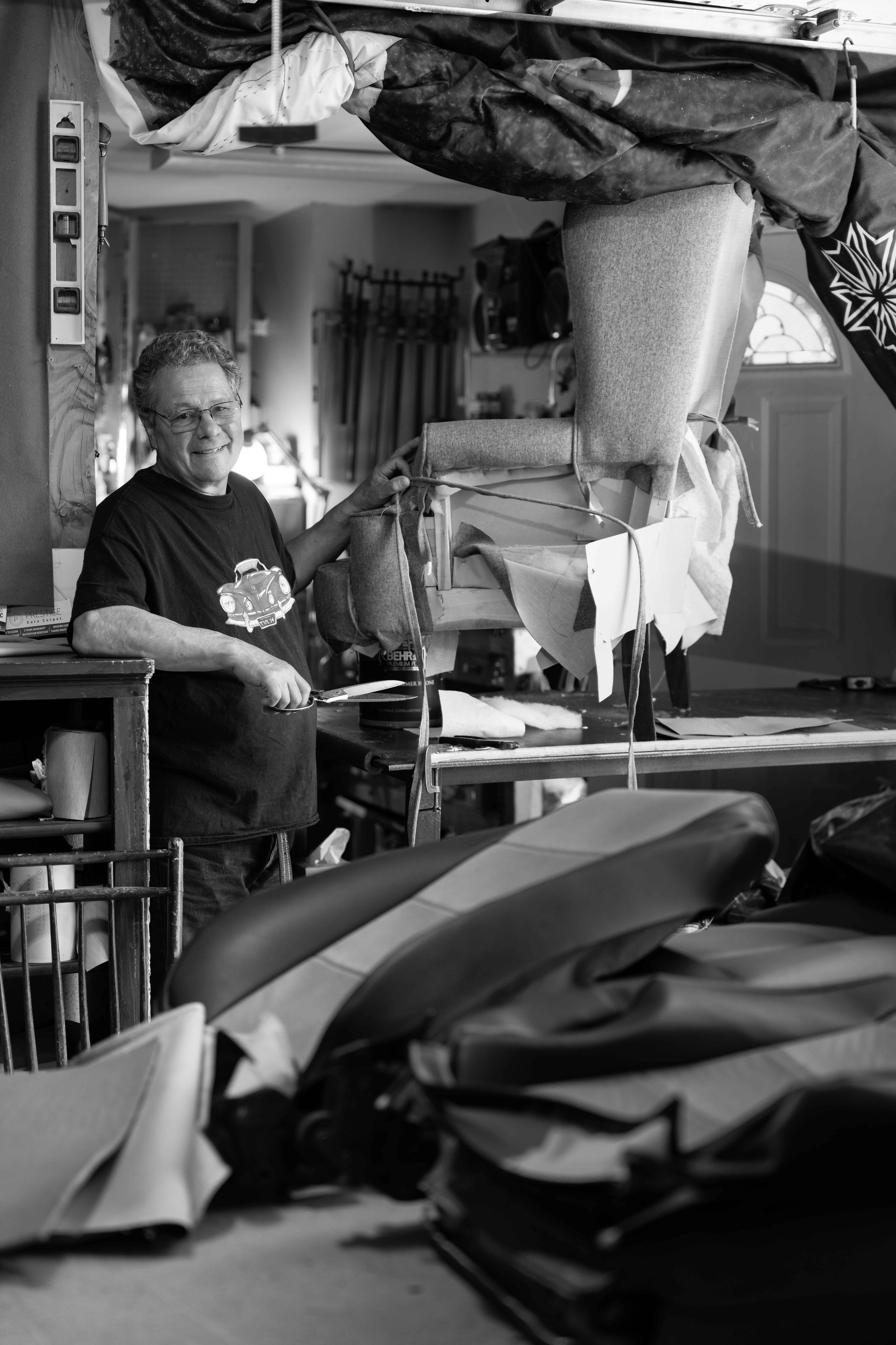 Dynamic black and white portrait of upholsterer in studio