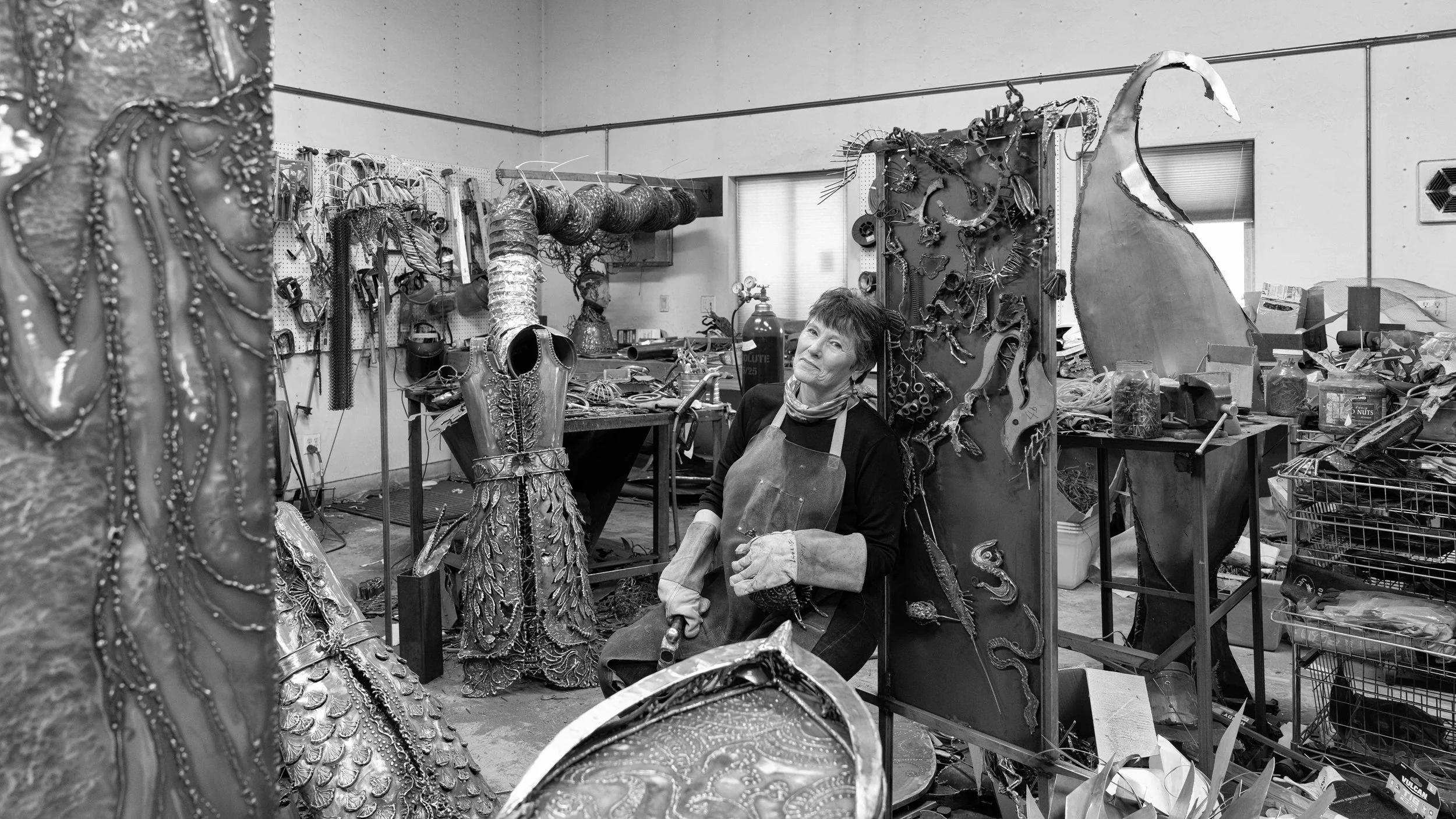 Black and white heirloom portrait of an artist in her studio