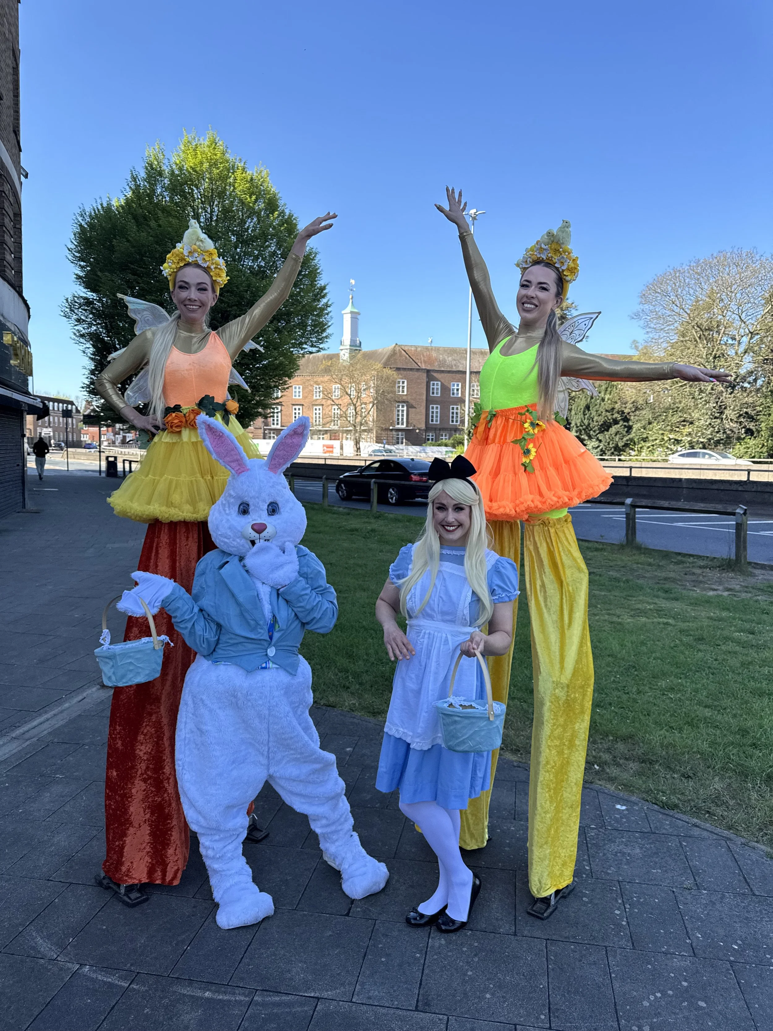 Stilt walking fairies, easter bunny mascot and Alice in wonderland on Watford high street for their easter event 