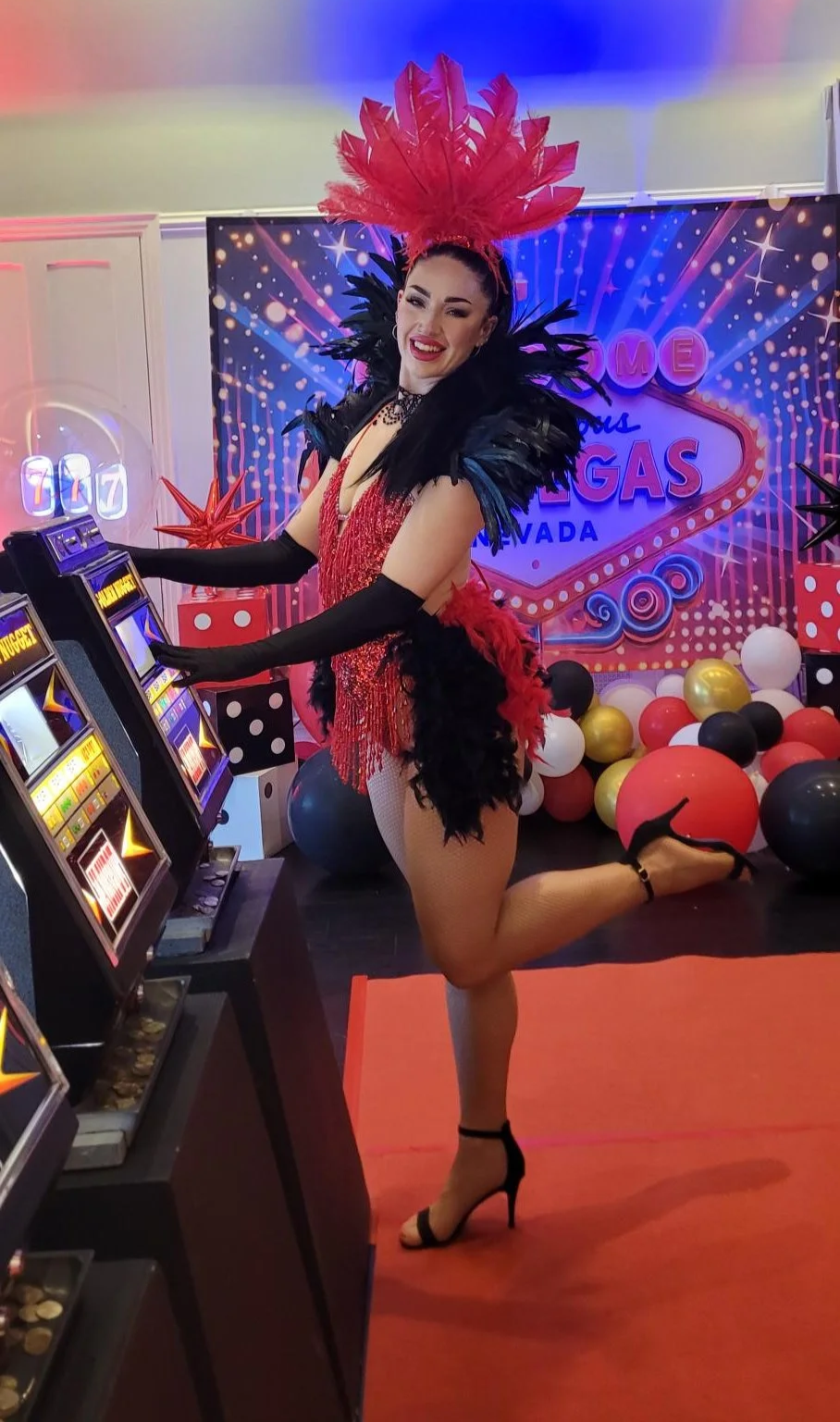 red and black showgirl dancer for viva Las Vegas corporate event in London with casino machines 