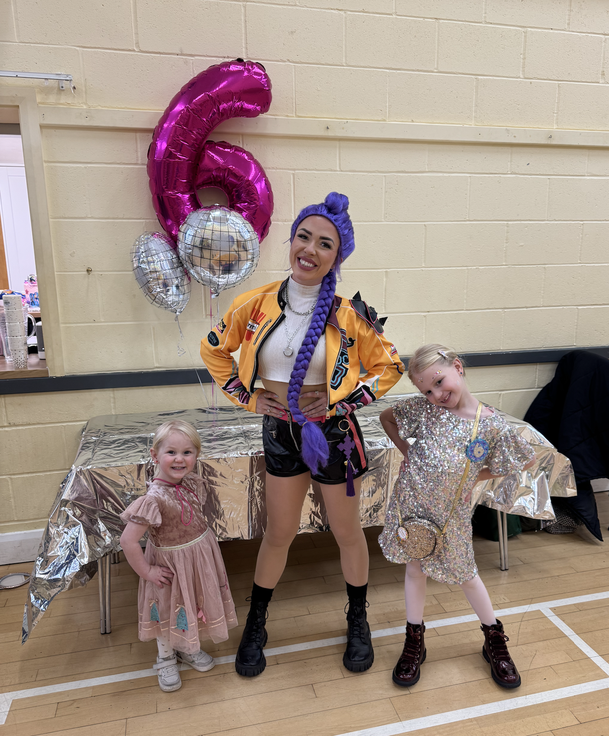 Kpop Demon Hunters Rumi posing with children at a 6th birthday party 