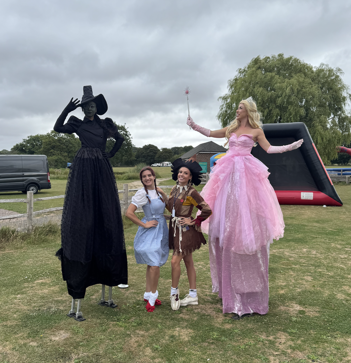 stilt walking elphaba and Glinda with Dorothy and scarecrow