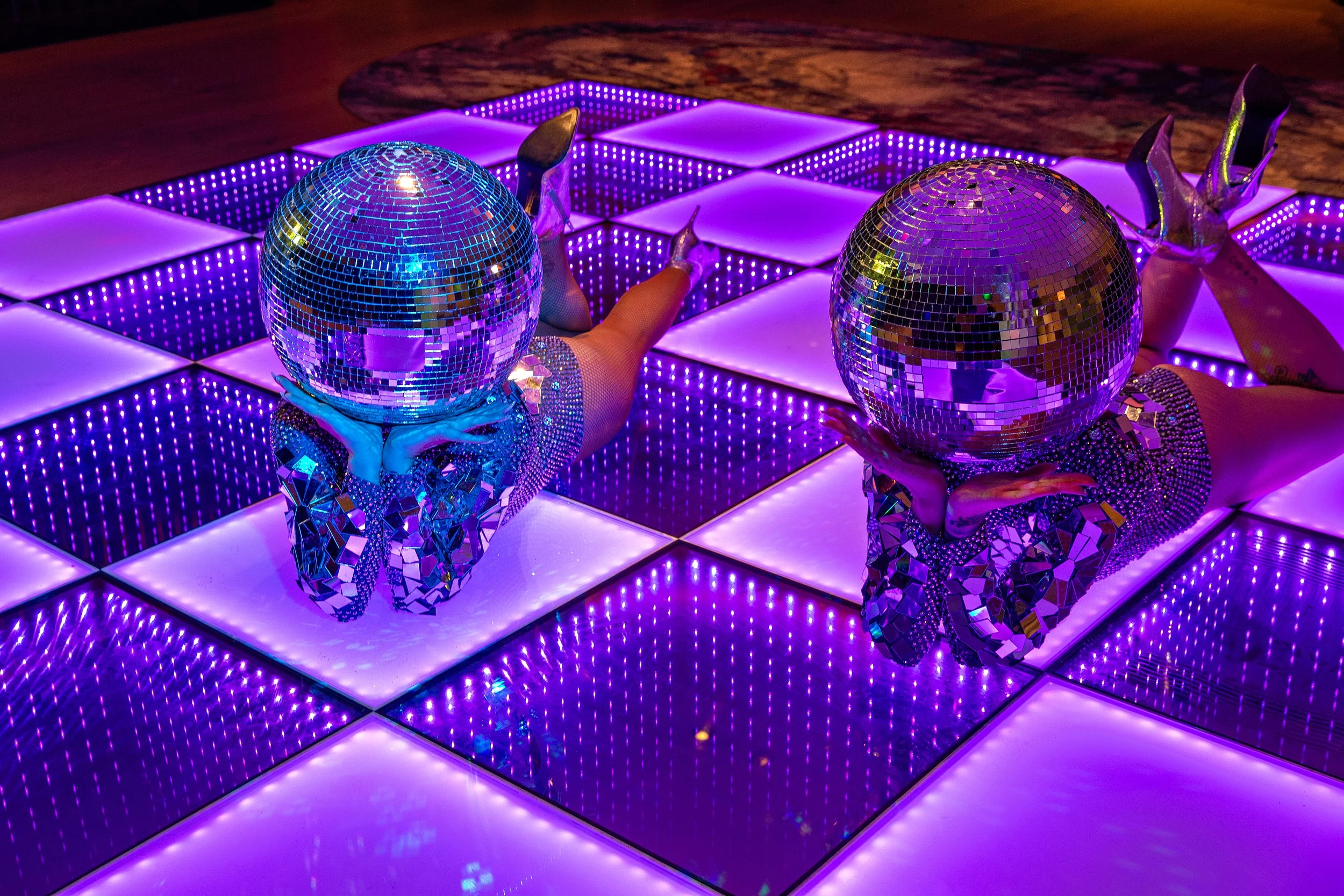 silver disco head dancers lying on LED dance floor at hyatt regency hotel Stratford 