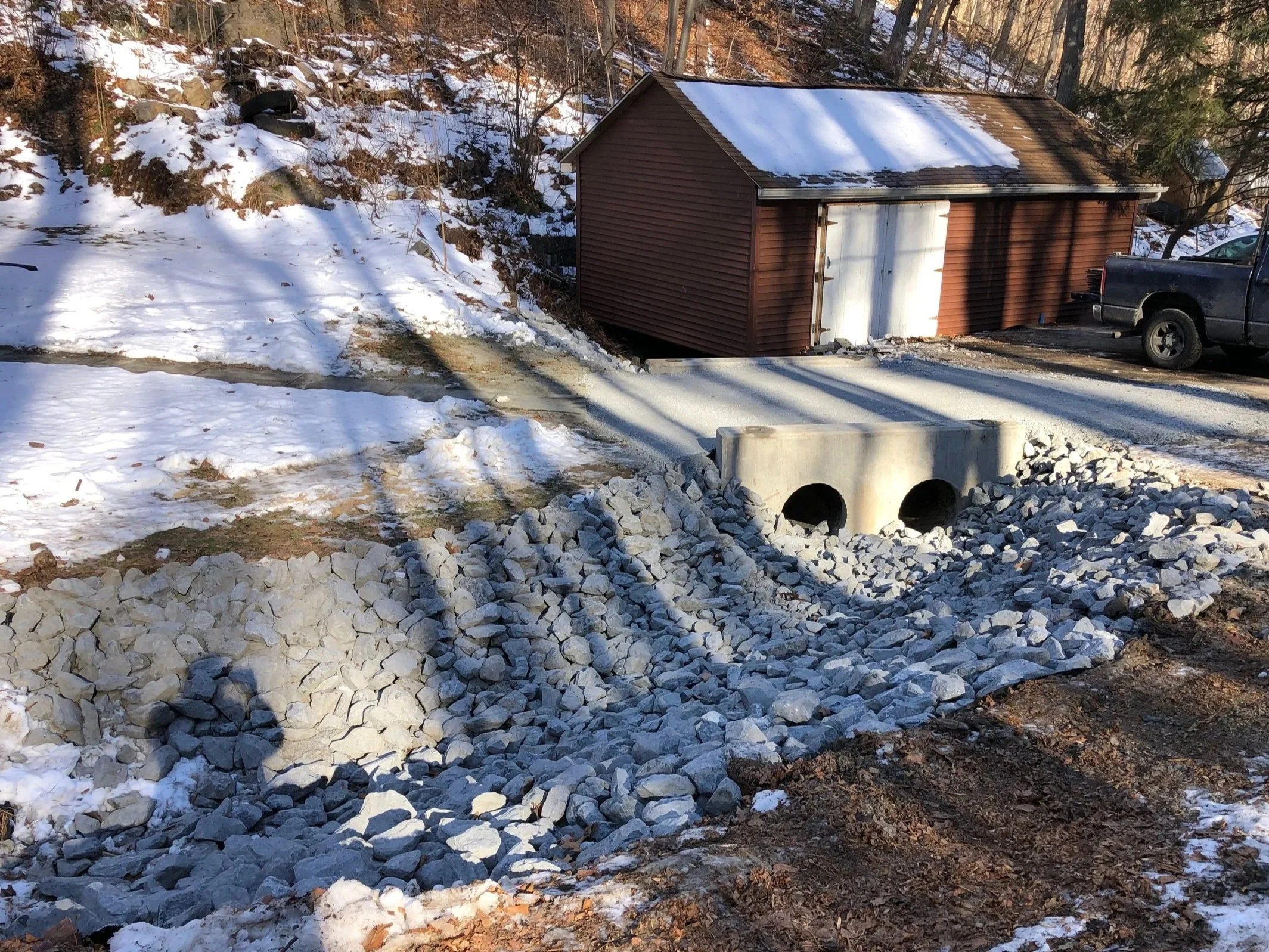  storm drain pipe, precast end walls and rip-rap swale for crossing.