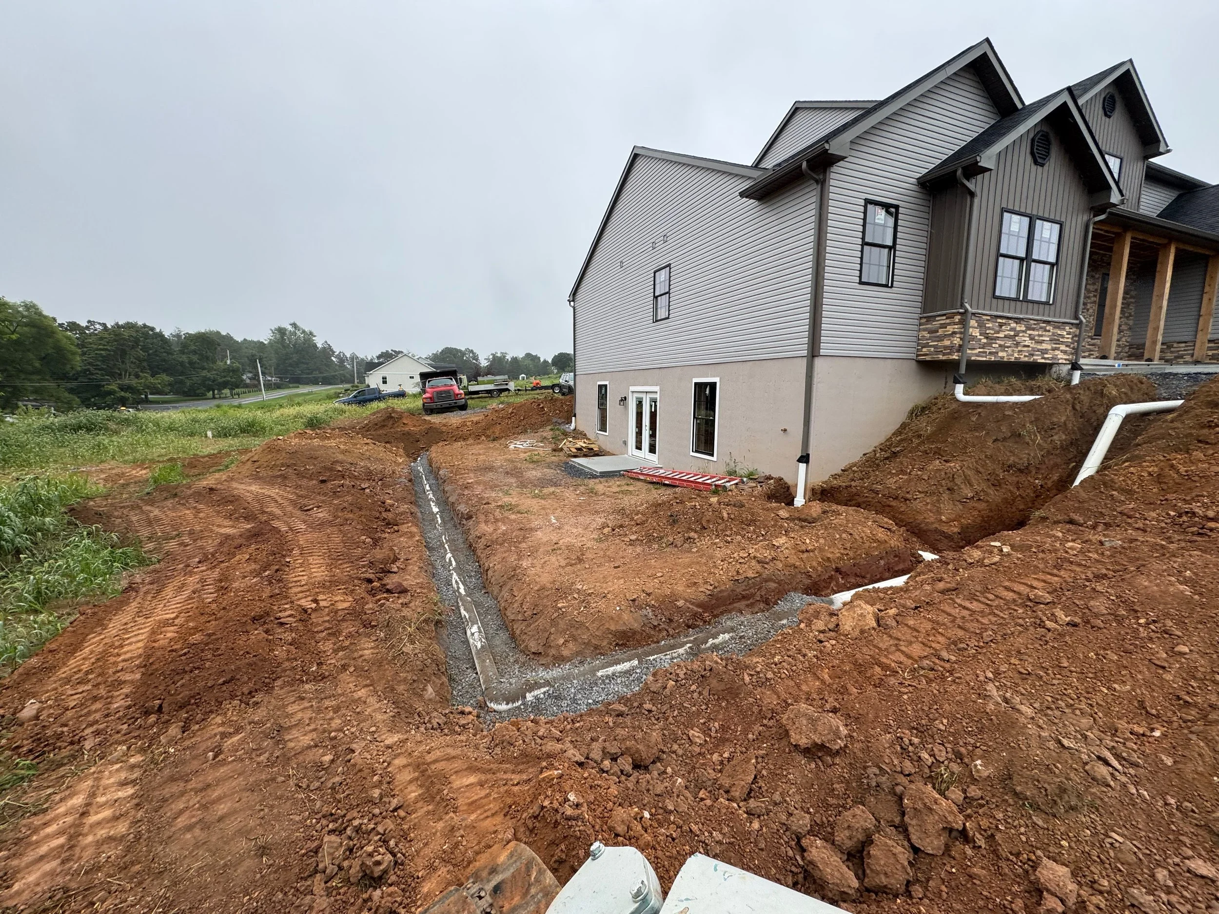 Excavation, stormwater retention, rain leaders, drain pipes and trenching