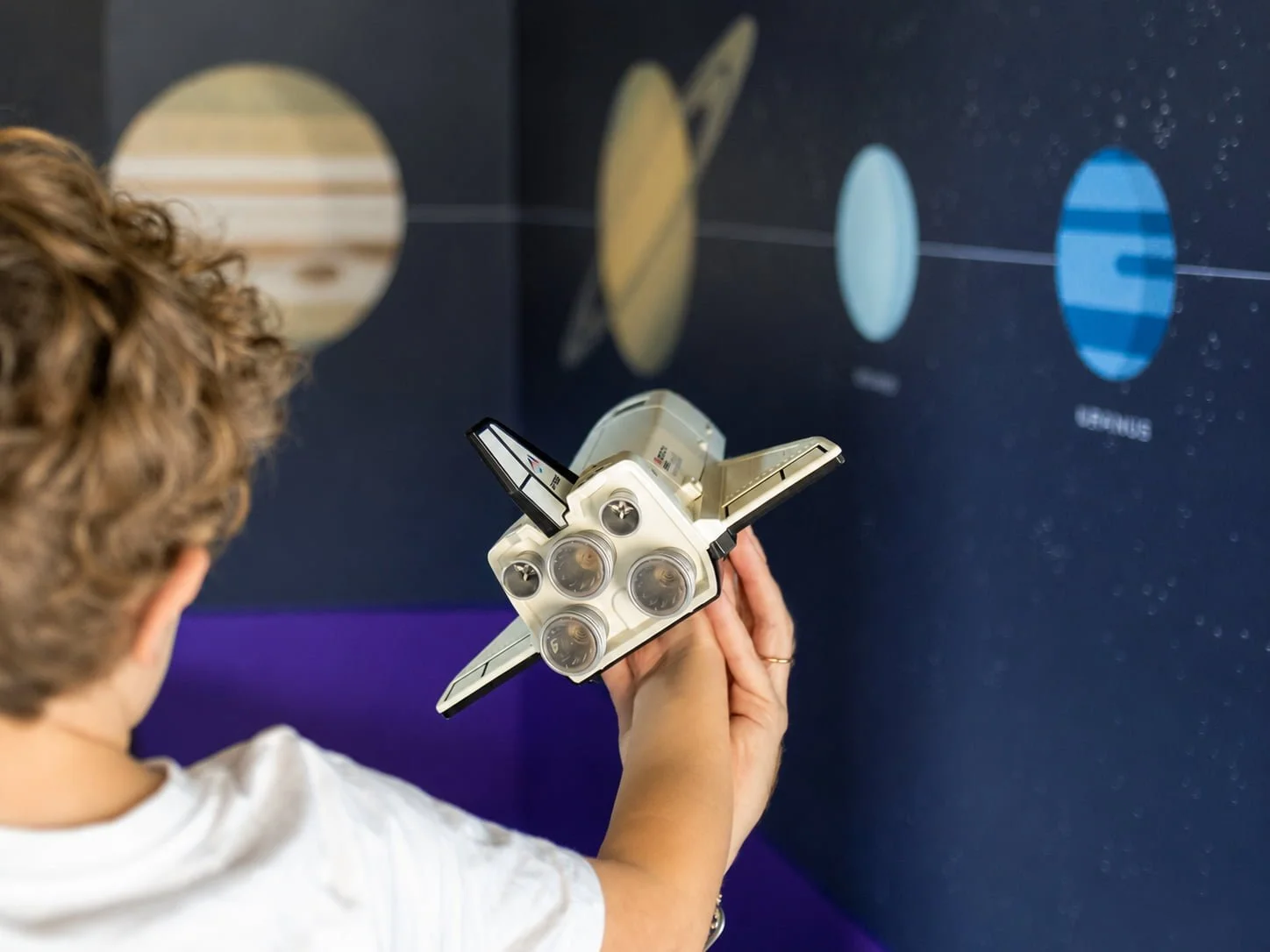 solar-system-mural-child-playing-toy-rocket-space-theme.jpg