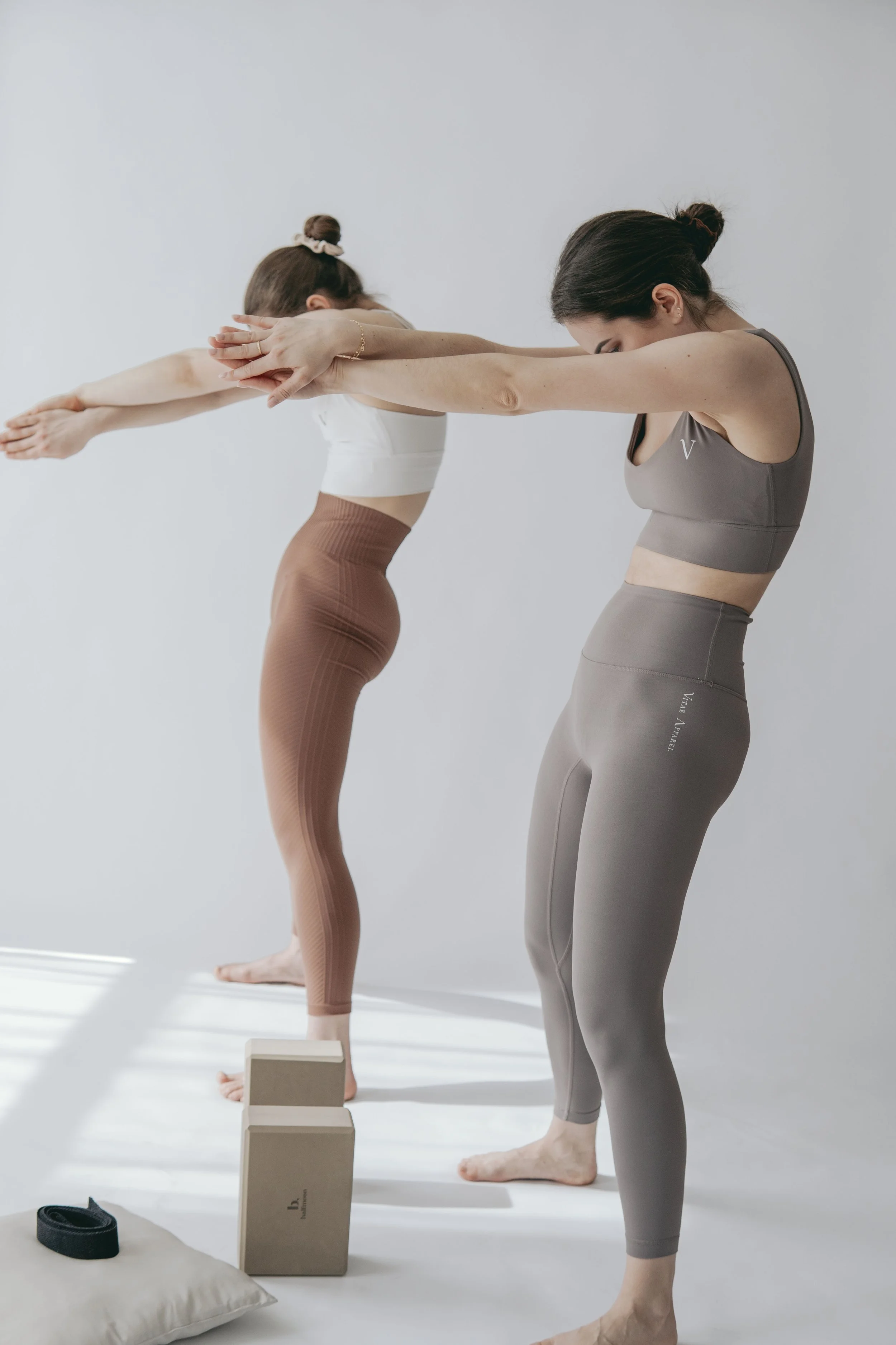 two women doing a back stretch