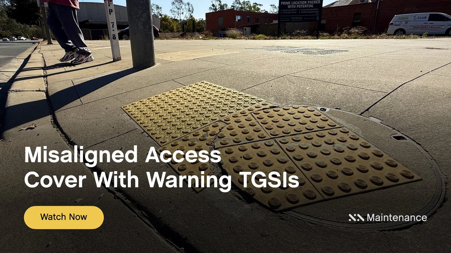 Staebl Academy - Banner for Learning Session - Footpath kerb ramp with misaligned tactile paving on an Access Cover (Man Hole), Warning Tactiles (TGSIs), near a light pole on a pedestrian crossing.