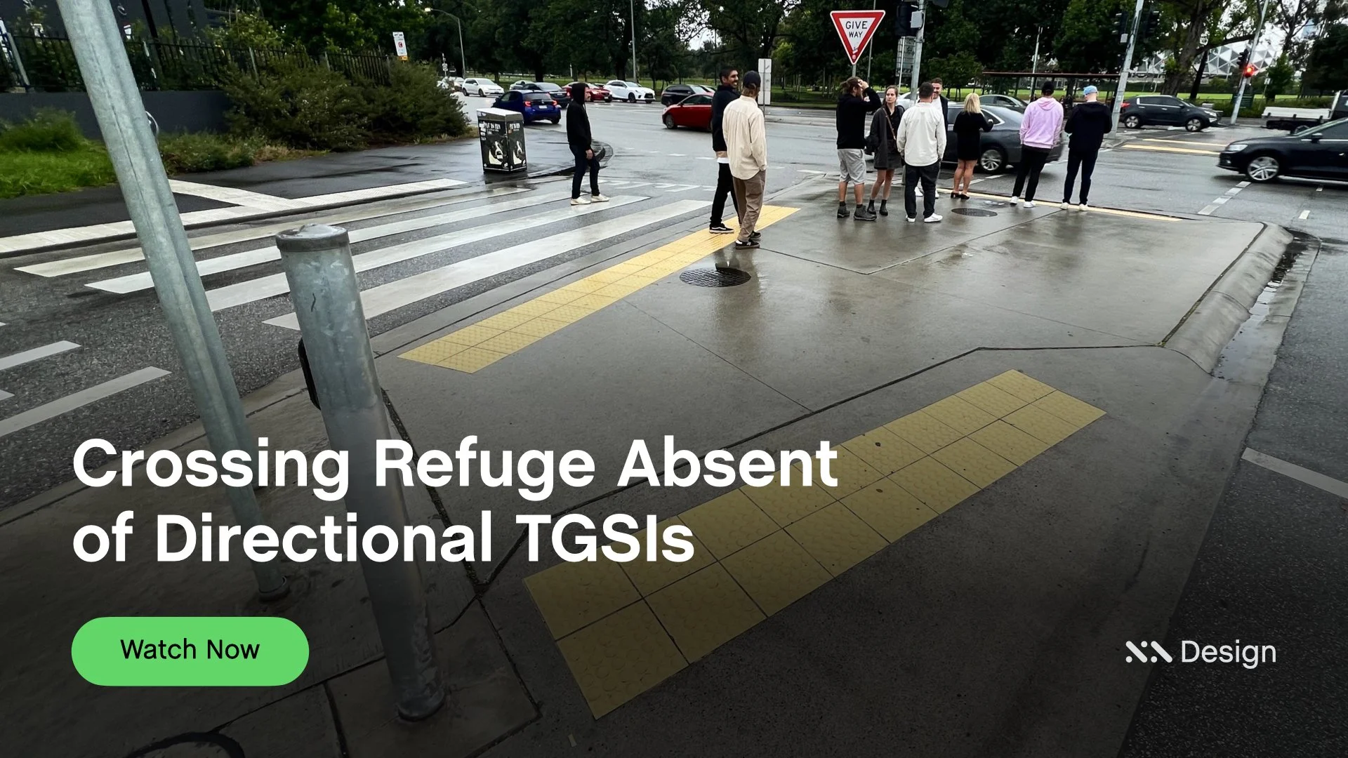 Staebl Academy - Banner for Learning Session - Intermediate Crossing Refuge with yellow tactile paving (Warning TGSIs) for vision impaired pedestrians, with a group of people waiting at the karb, overcast weather and multiple cars passing by.
