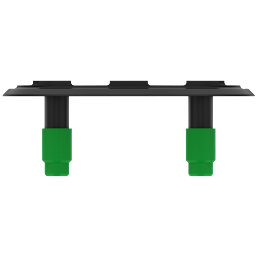 Black component resting on a flat gray surface with two green feet beneath it.