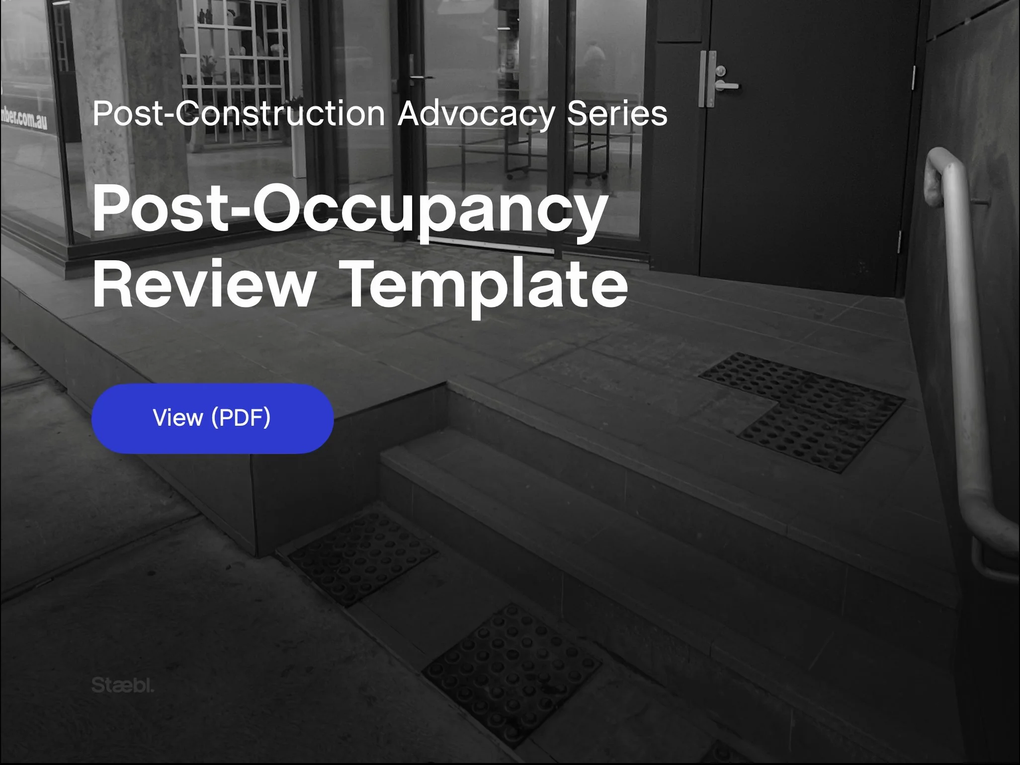 Post-Occupancy Review Template banner image showing an accessible building entrance with steps, handrails and tactile ground surface indicators used to review how accessibility outcomes perform after occupation.