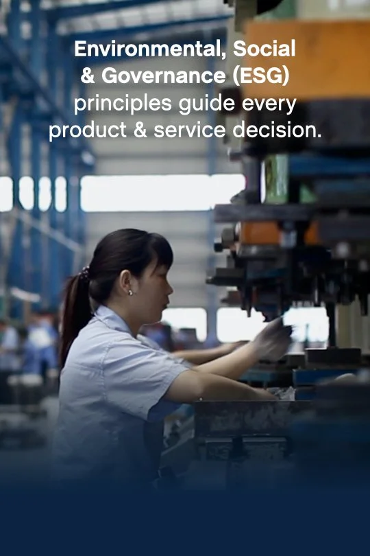 Woman working in an industrial warehouse or factory with shelves and equipment, with a text overlay about ESG principles guiding product and service decisions.