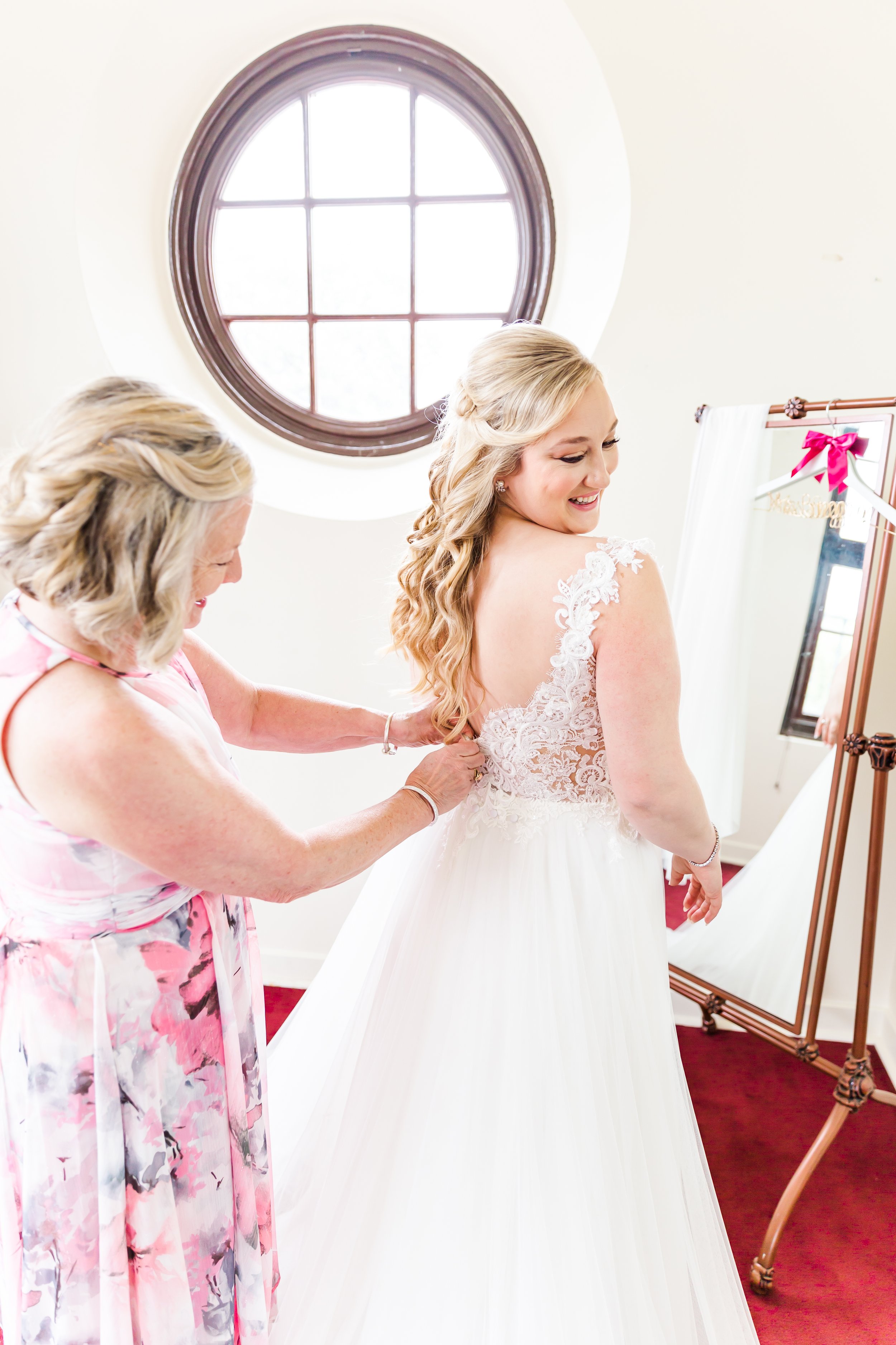 Mother helping bride get ready