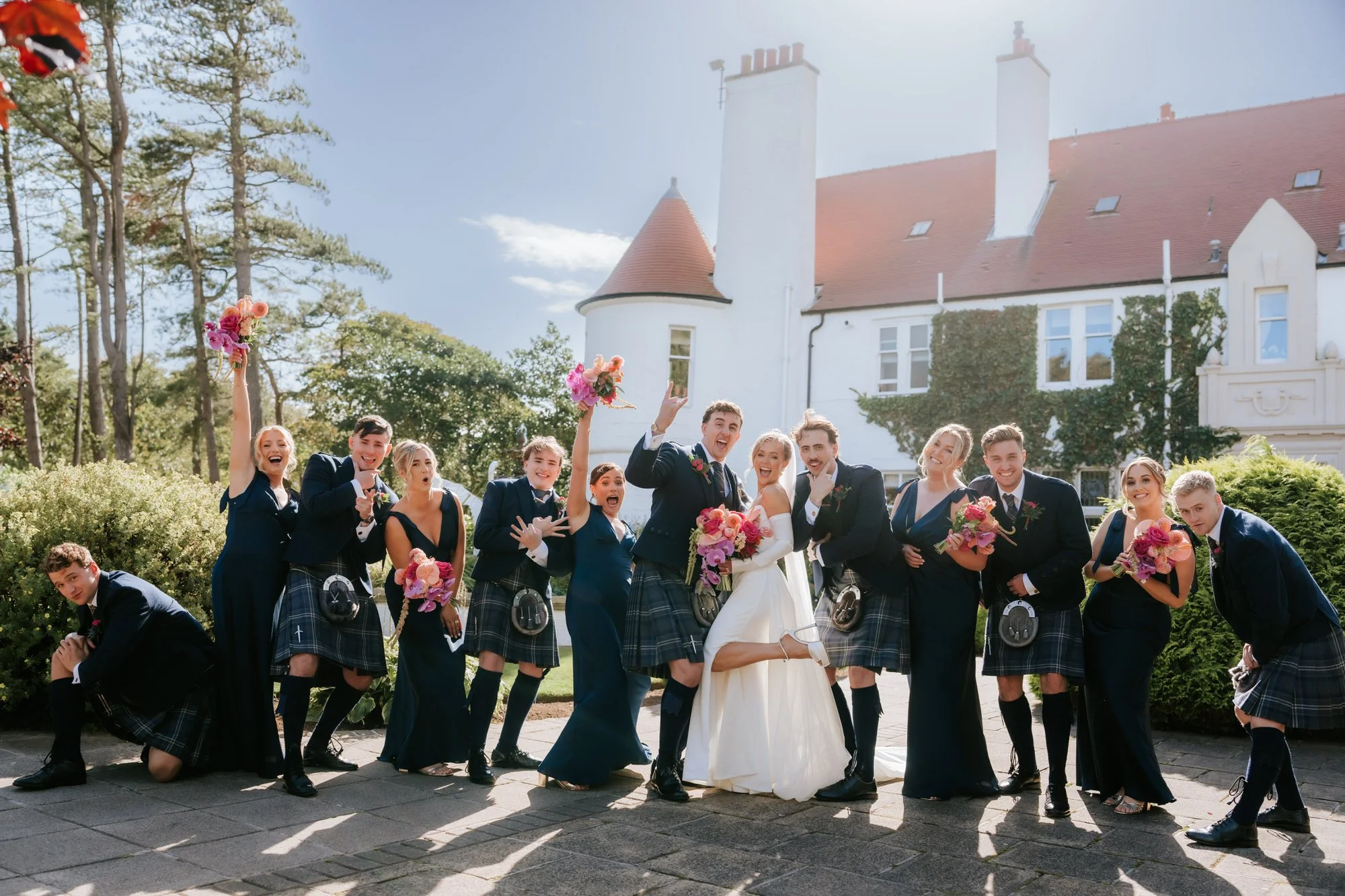 The wedding party celebrating outside Lochgreen House Hotel.