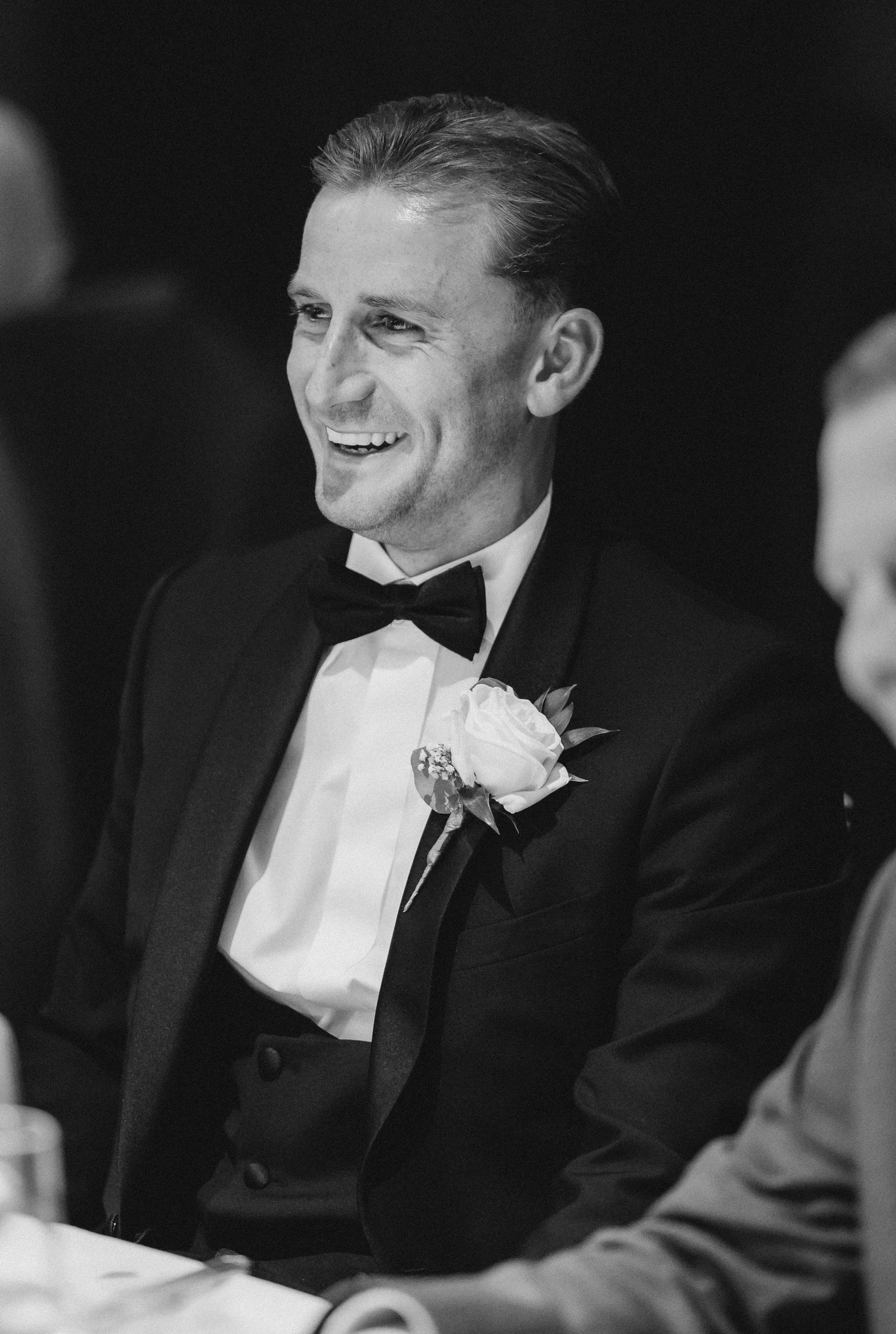 Black-and-white portrait of Frazer smiling during the reception.