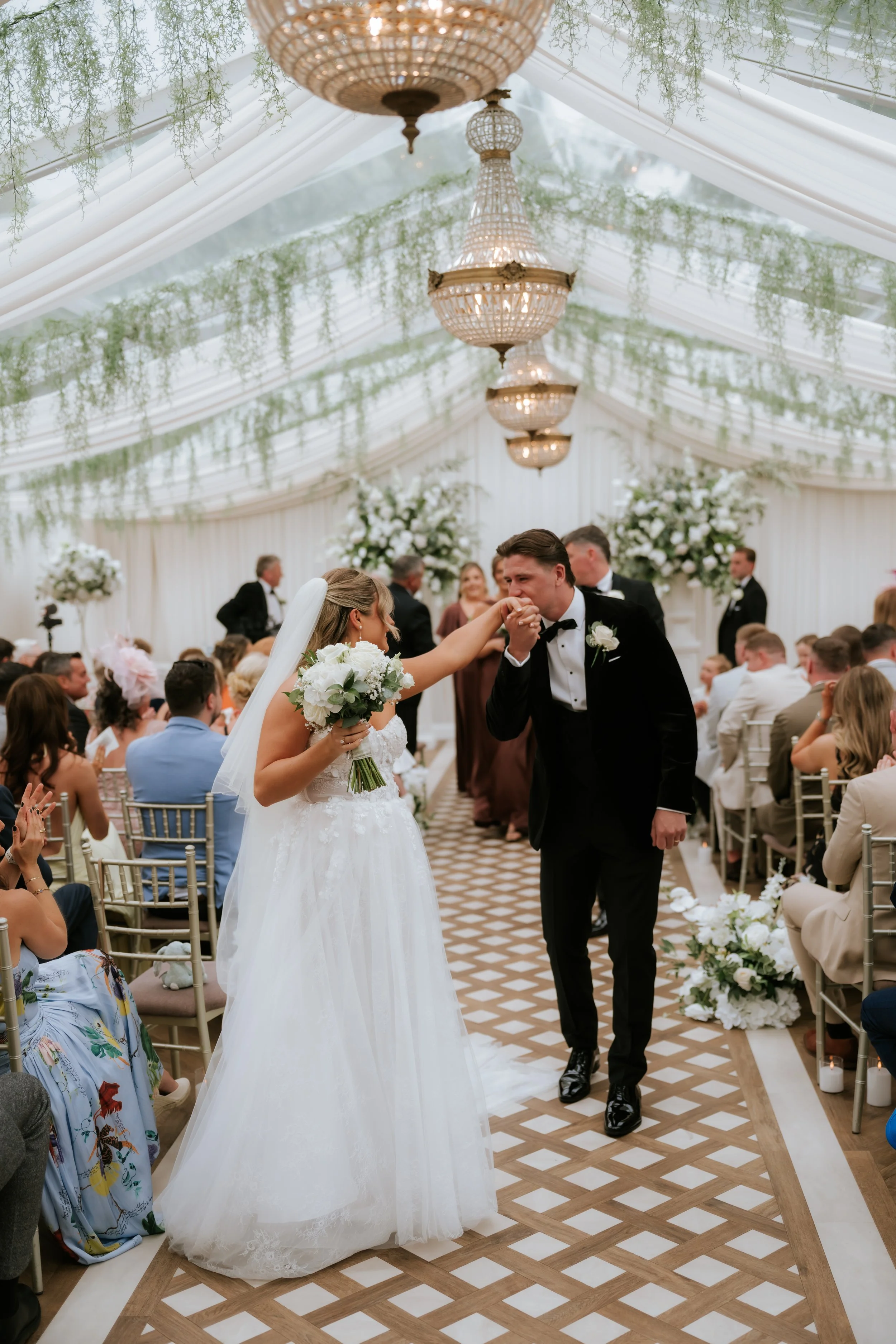 Emma and Frazer walking back down the aisle together after their ceremony.