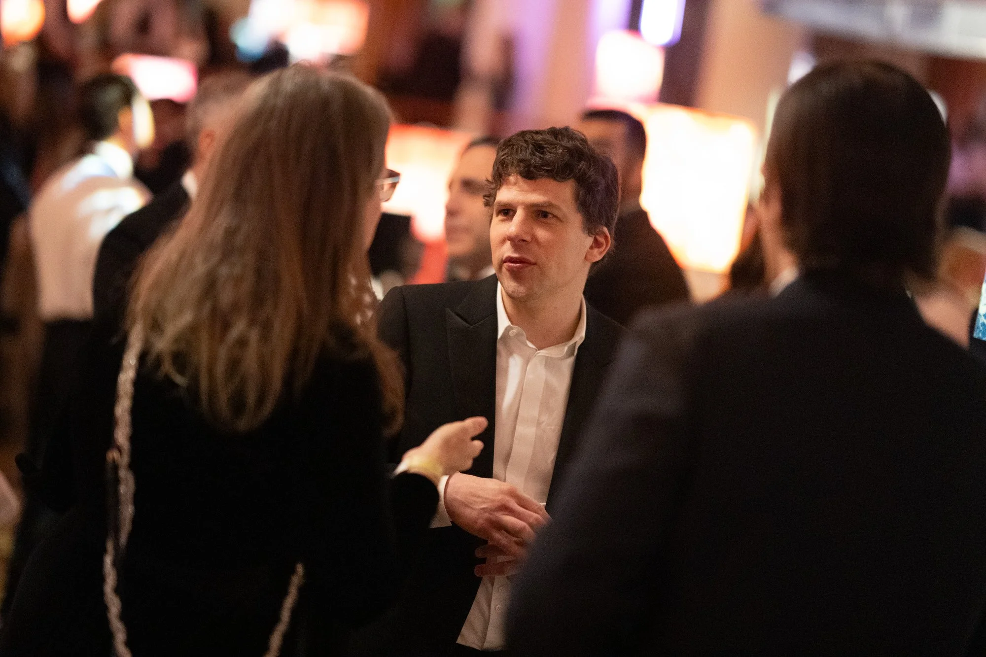 Jesse Eisenberg in conversation at the dinner following the 2025 BAFTA Film Awards.