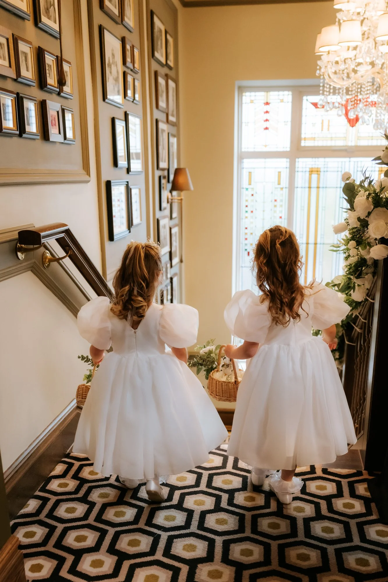 Two flower girls descending the staircase at Boclair House