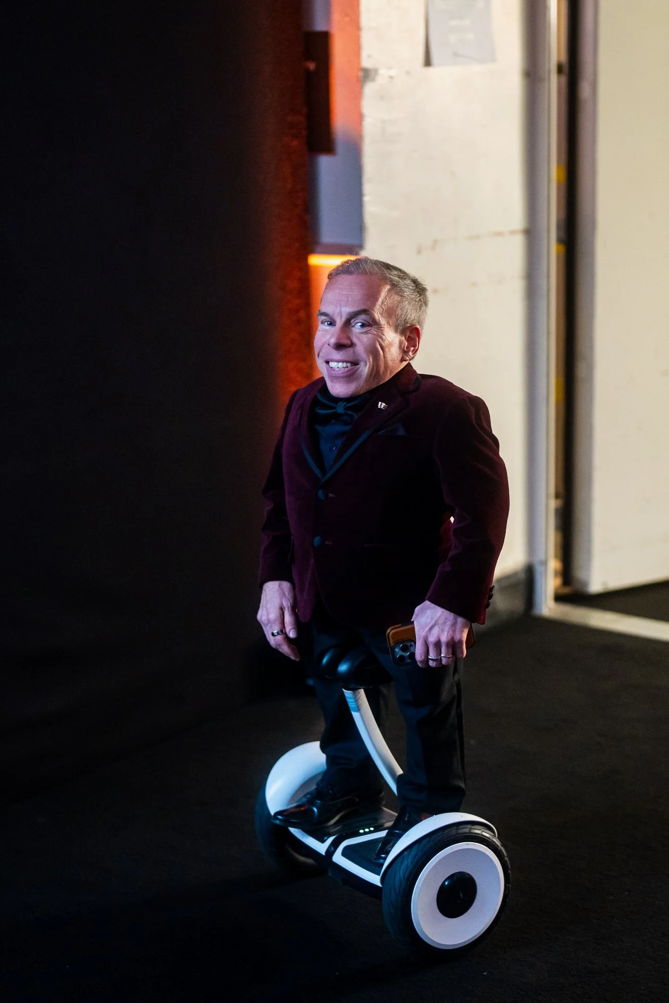 Warwick Davis backstage on his Segway at the 2025 BAFTA Film Awards.