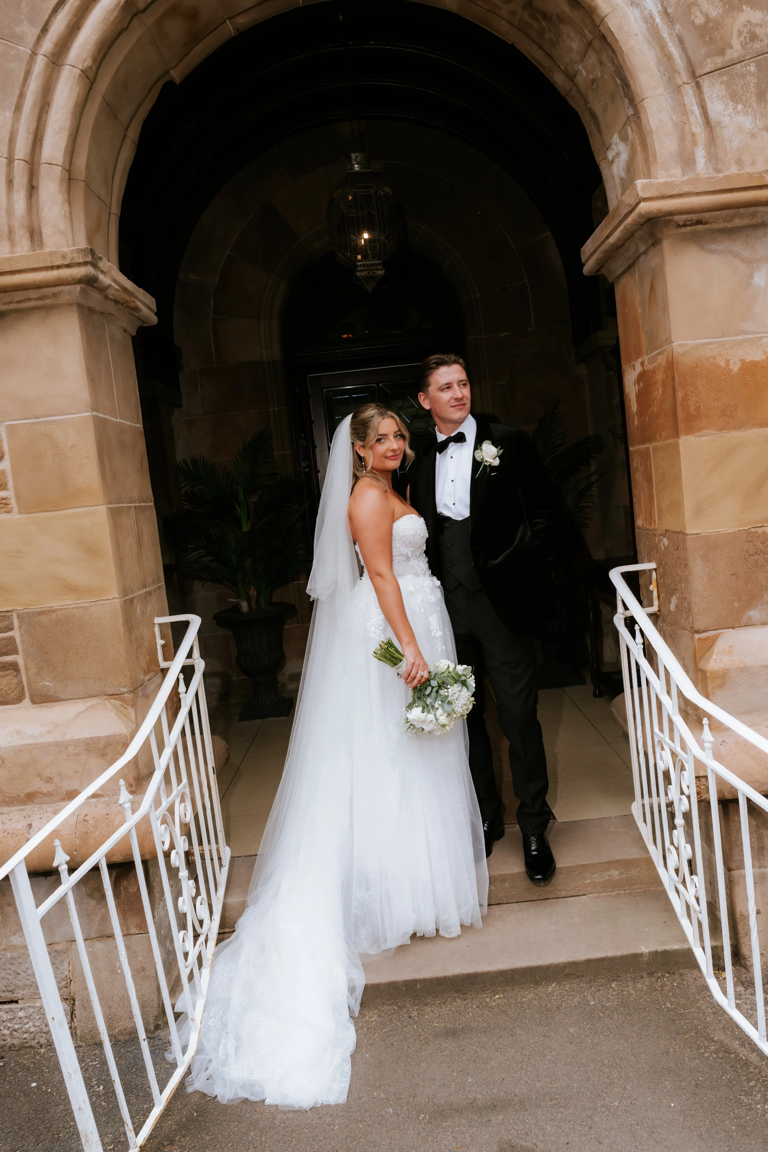Emma and Frazer standing together in Cornhill Castle’s stone doorway.